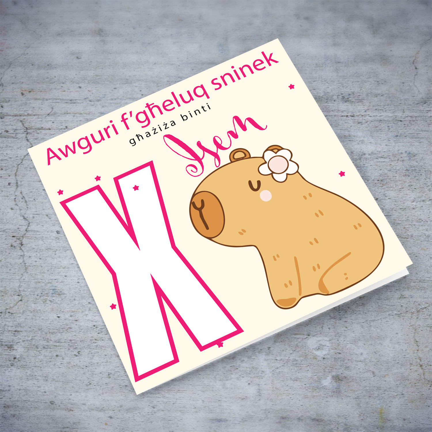 A cute birthday card for daughter featuring a capybara wearing a flower, personalisable with name and age in pink tones in Maltese (Personalisable + Enter Age)