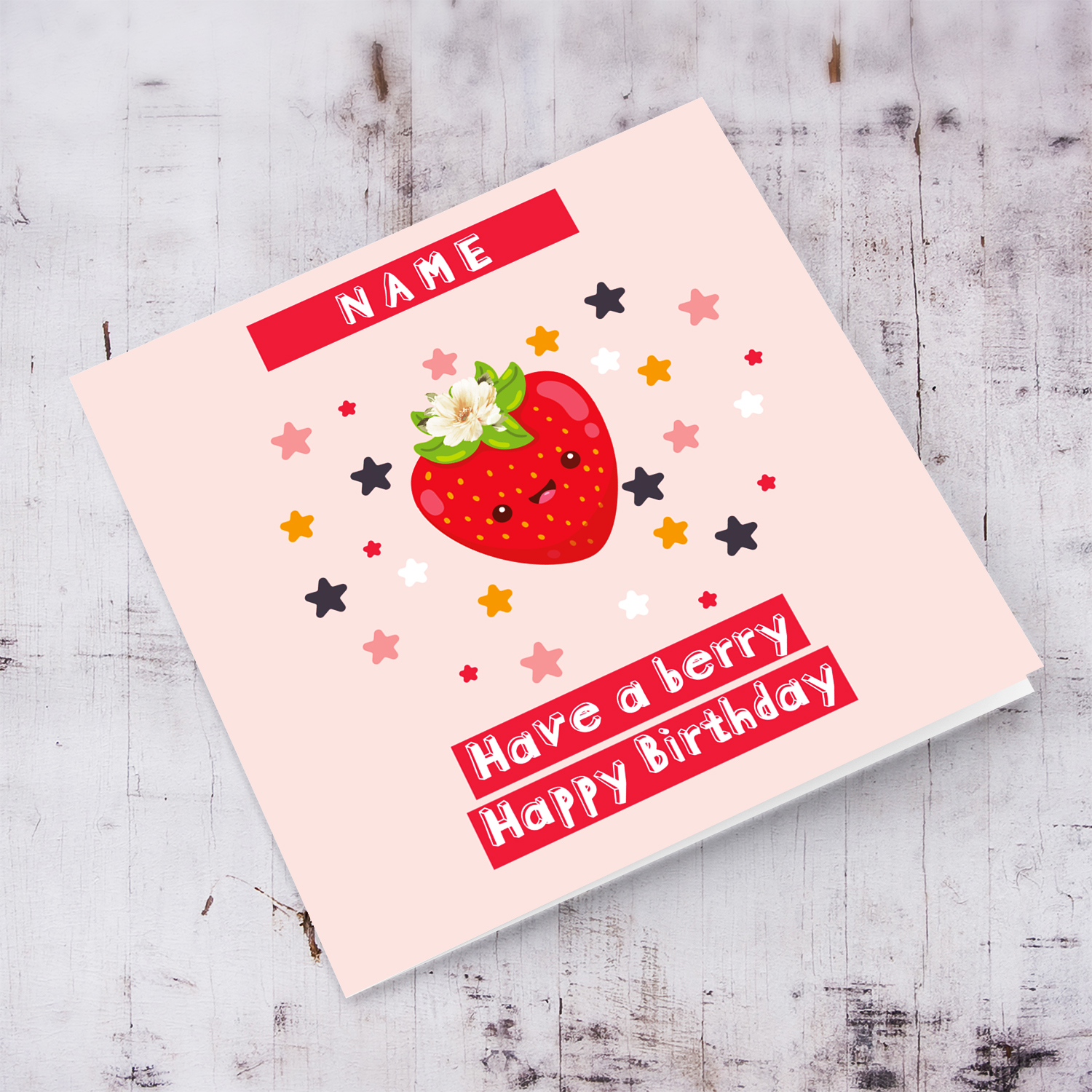 A cute birthday card featuring a strawberry with a white flower, scattered colourful stars in pink background in English (Personalisable)