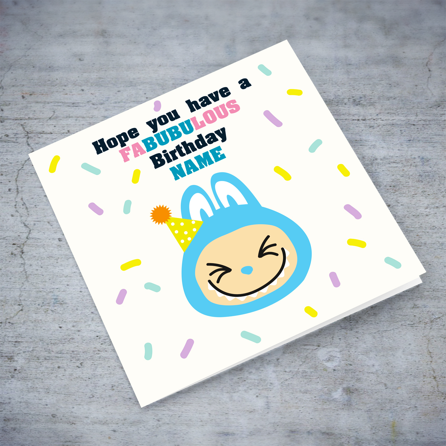 Blue labubu themed birthday card featuring a blue labubu wearing a party hat, and scattered colourful confetti in English (Personalisable) 