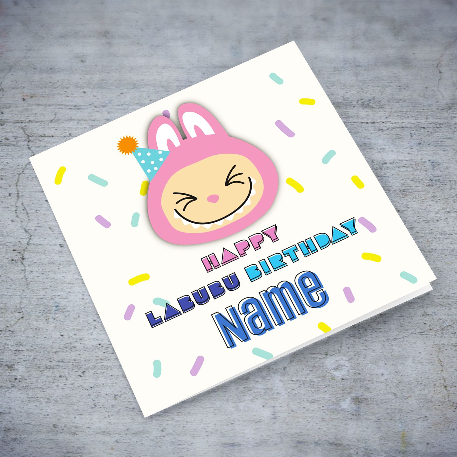A colourful birthday card featuring a big pink labubu wearing a party hat, with colourful confetti in English (Personalisable)