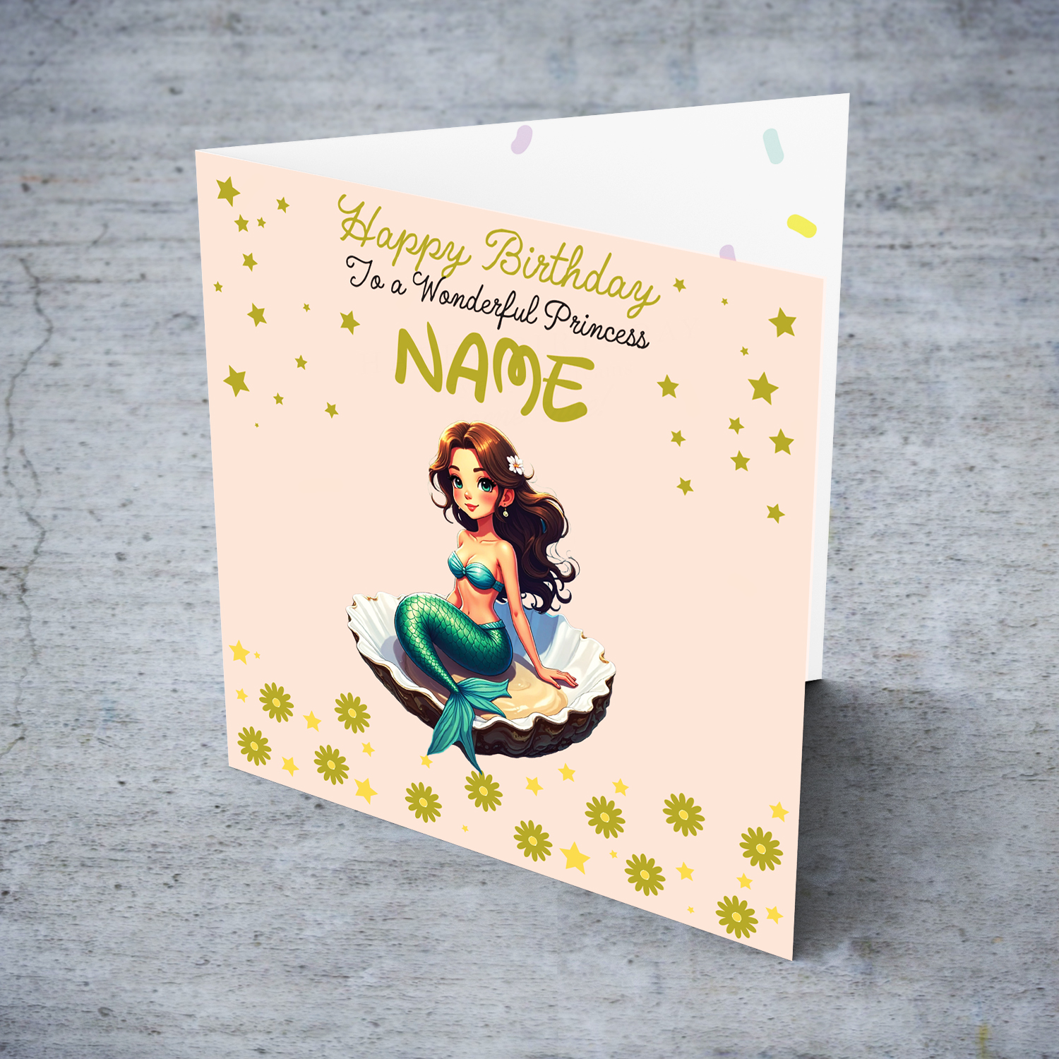 A cute birthday card in light pink background with a brunette mermaid, sitting in an oyster shell, with golden stars and flowers in English