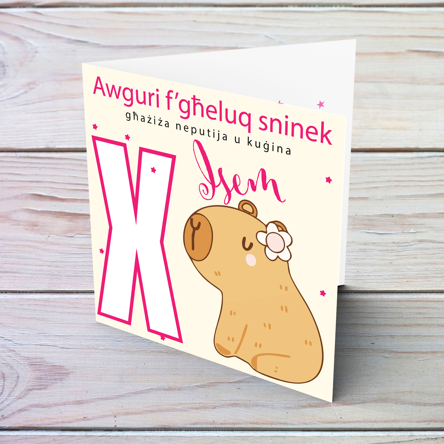 A cute birthday card for niece & cousin featuring a capybara wearing a flower, personalisable with name and age in pink tones in Maltese (Personalisable + Enter Age)