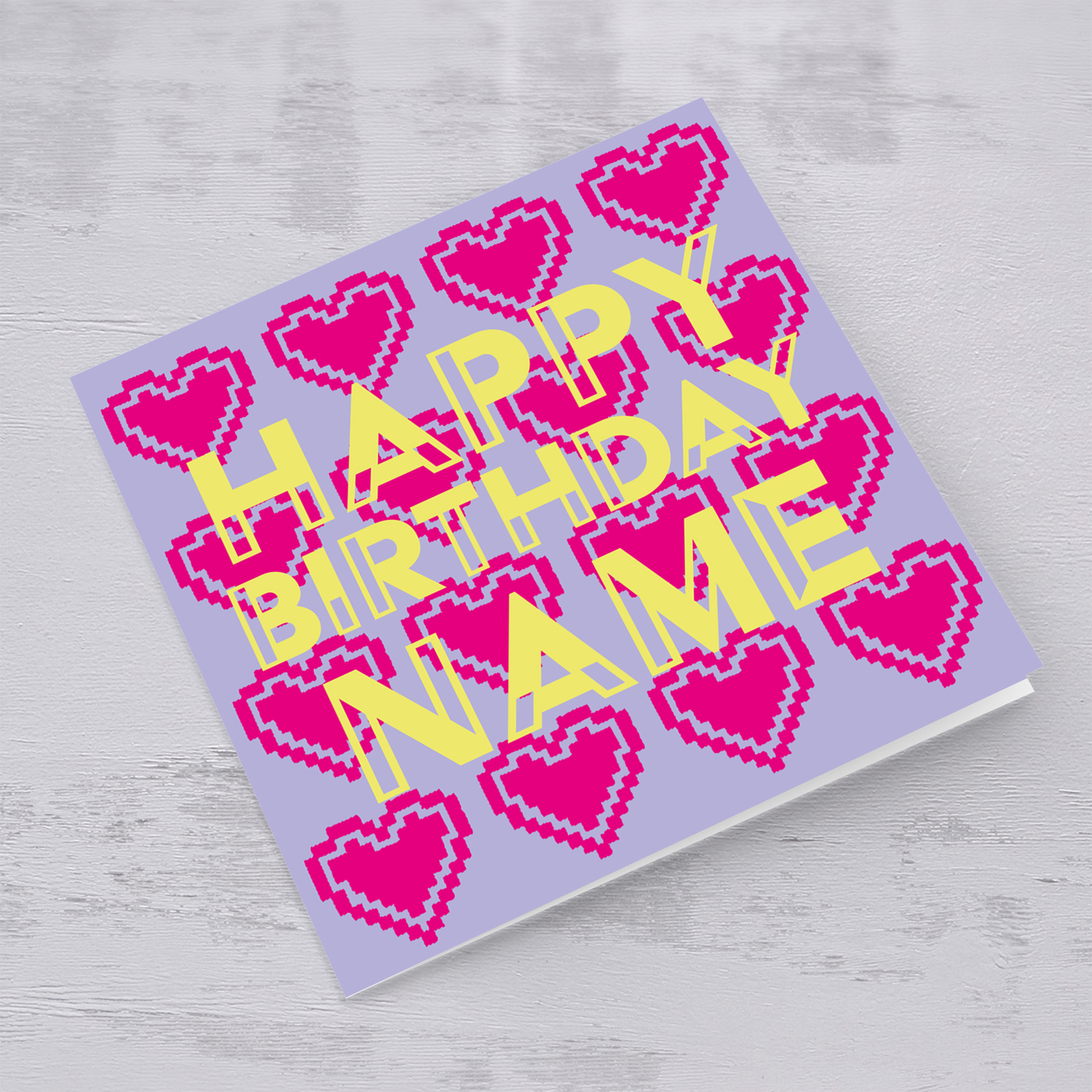 Pixelated pink heart themed personalisable birthday card with yellow text in English
