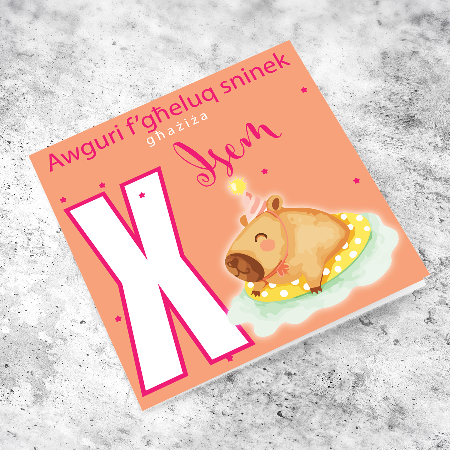 A cute birthday card for someone dear featuring a capybara swimming and wearing a party hat, personalisable with name and age in pink tones in Maltese (Personalisable + Enter Age)