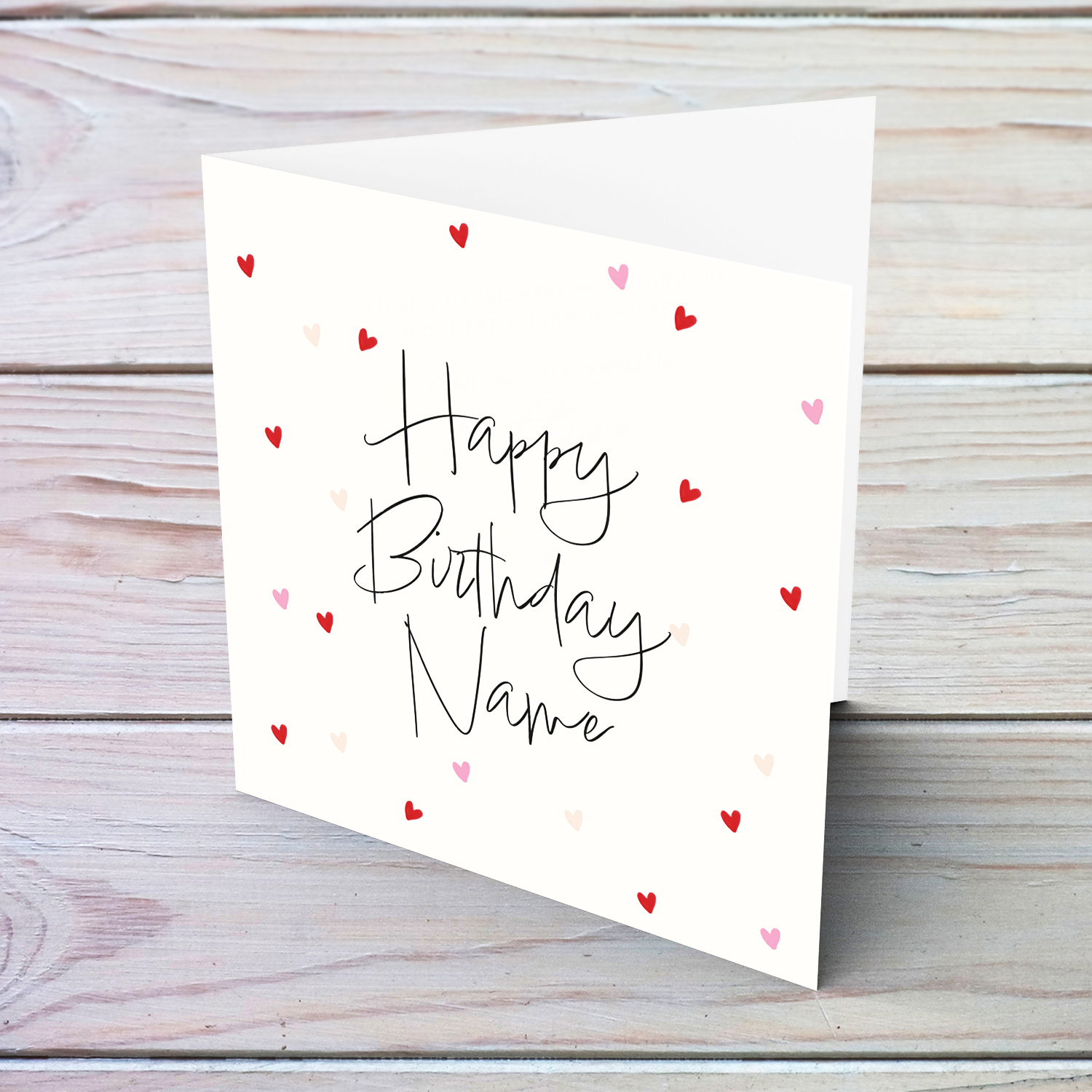 A cream coloured birthday card with scattered red and pink hearts in English (Personalisable)