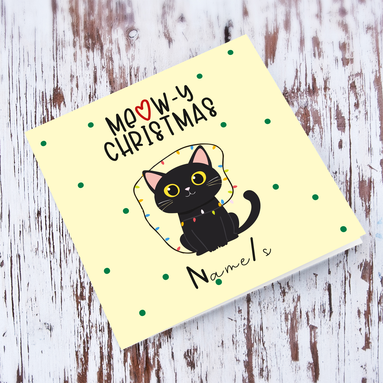 Cute cat with Christmas lights in light cream background and scattered green dots Christmas card in English (personalisable)