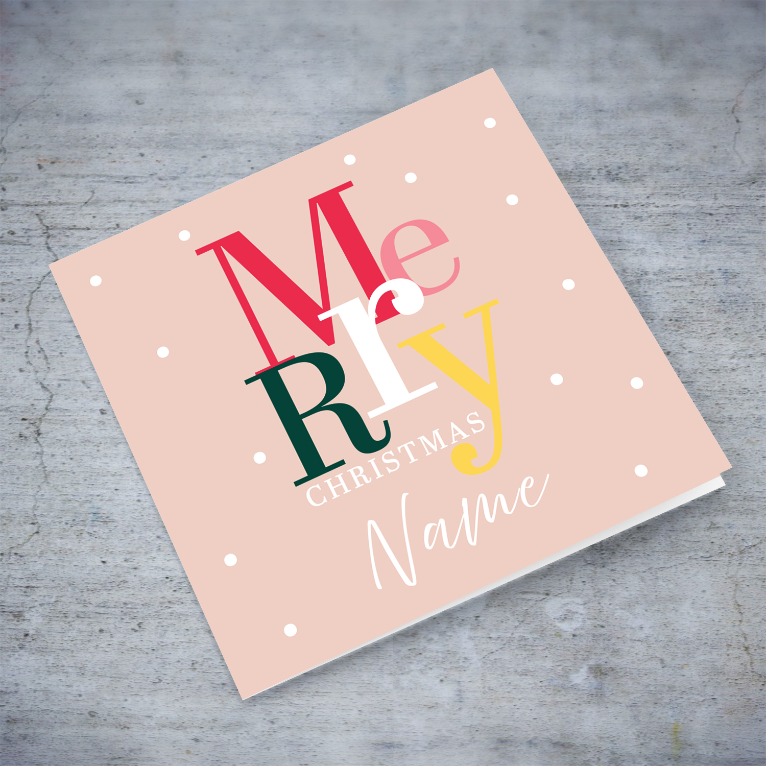 A cheerful open Christmas card with a light pink background and colourful text in English