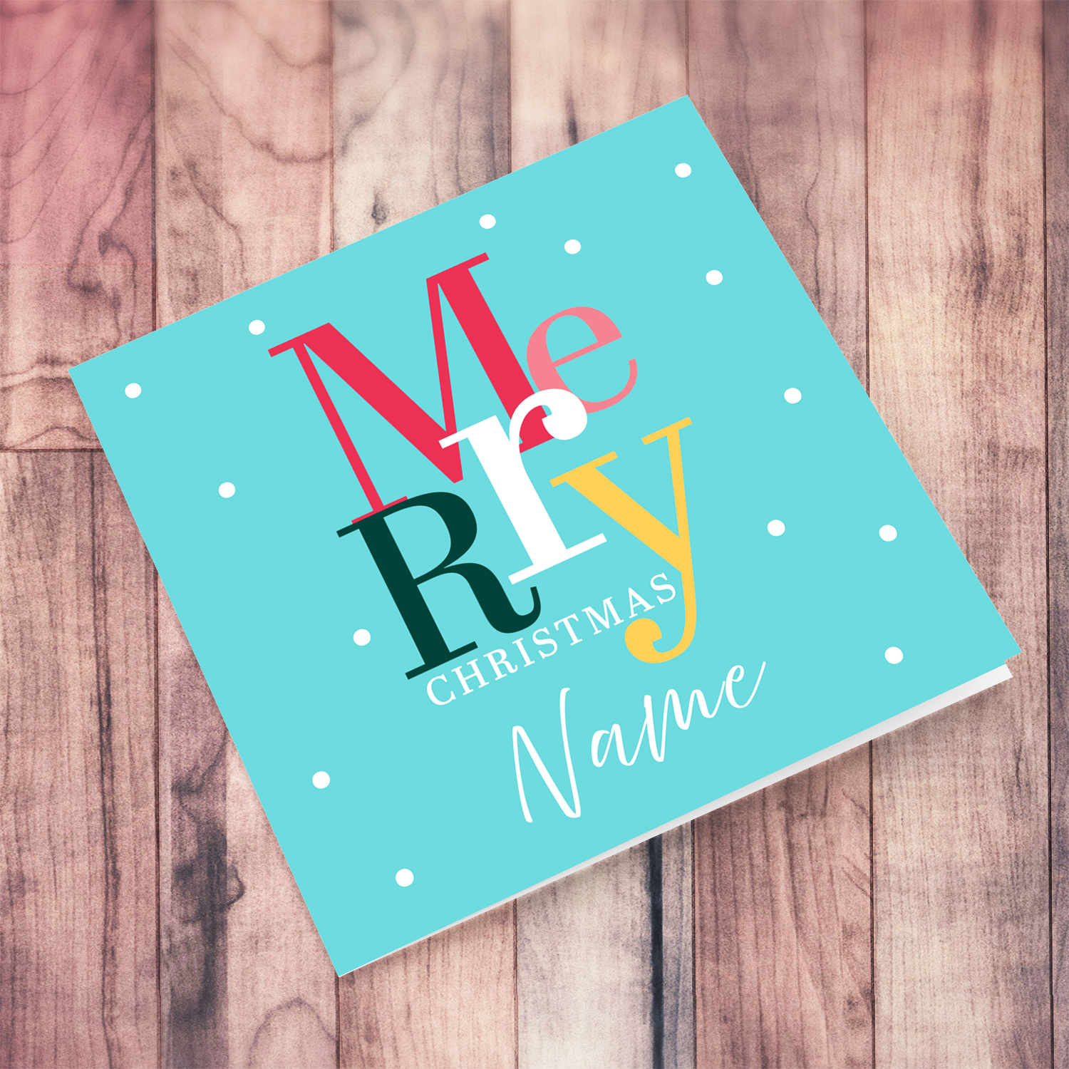 A cheerful open Christmas card with a light blue / teal background and colourful text in English