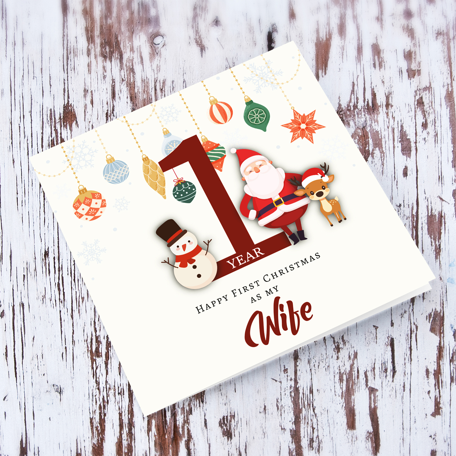 A special First Christmas card, featuring hanging baubles with a cute snowman, santa, and reindeer for Wife in English