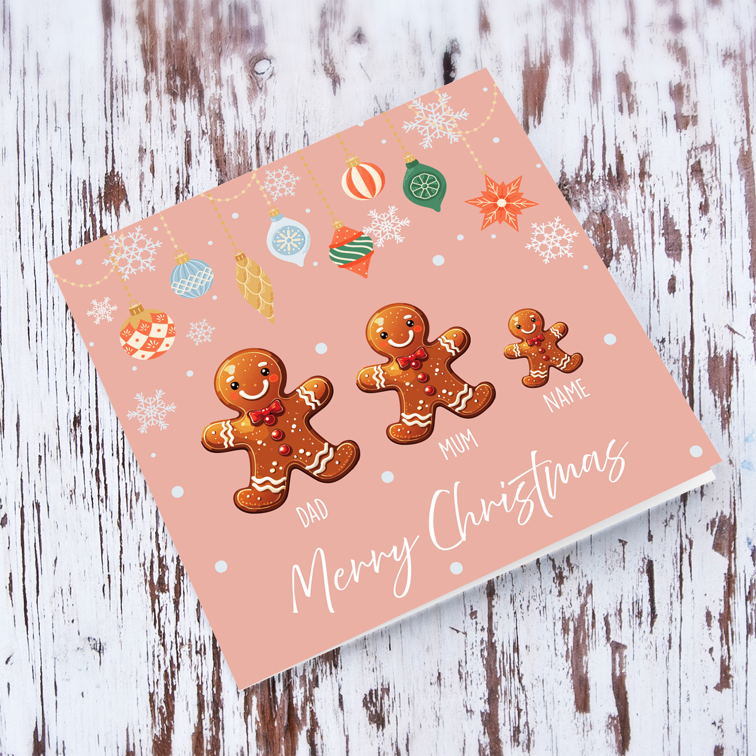 A cute Christmas card, featuring a family of ginger breadman with 1 child, pink background and hanging snowflakes in English (Personalisable)