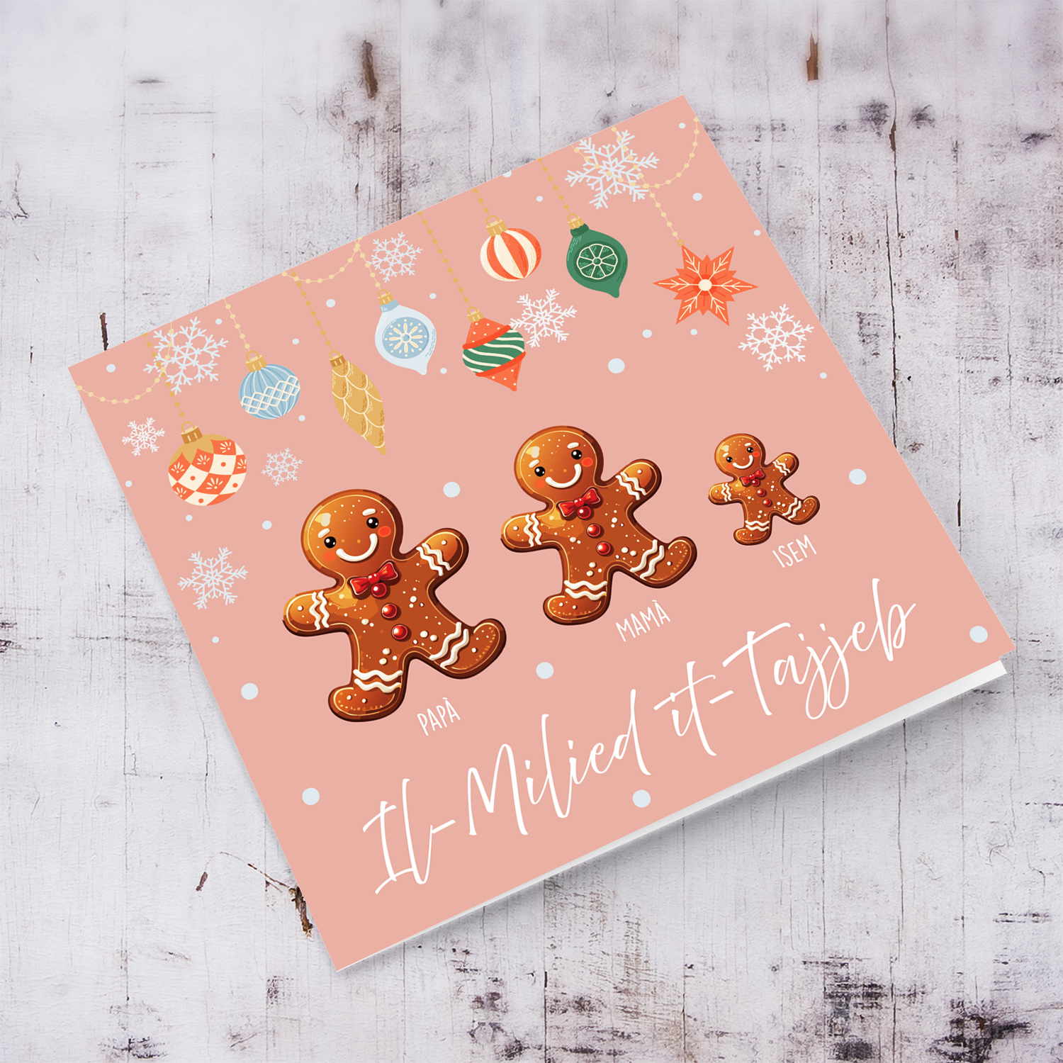A cute Christmas card, featuring a family of ginger breadman with 1 child, in pink background & hanging snowflakes in Maltese (Personalisable)
