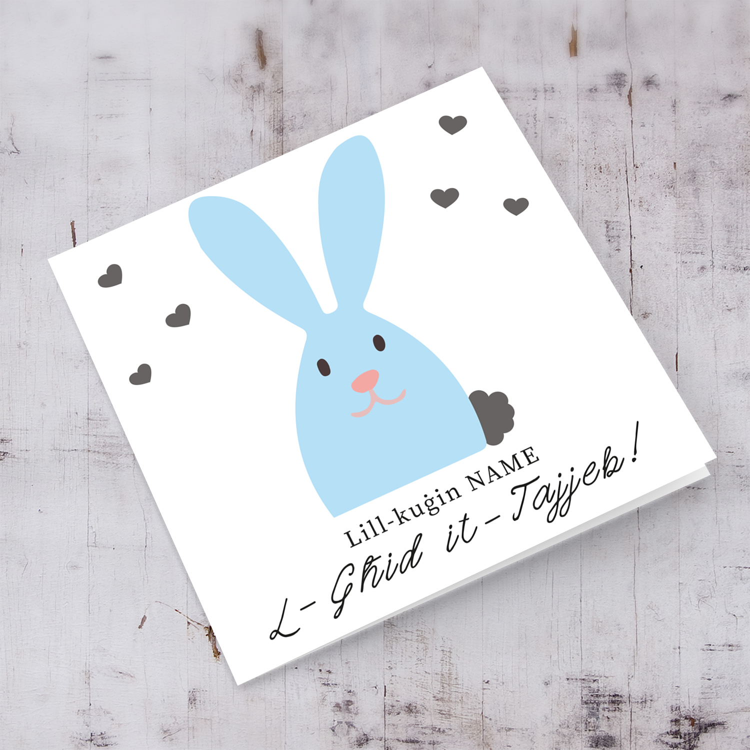 Cousin personalisable Easter card with cute blue bunny and scattered hearts in Maltese