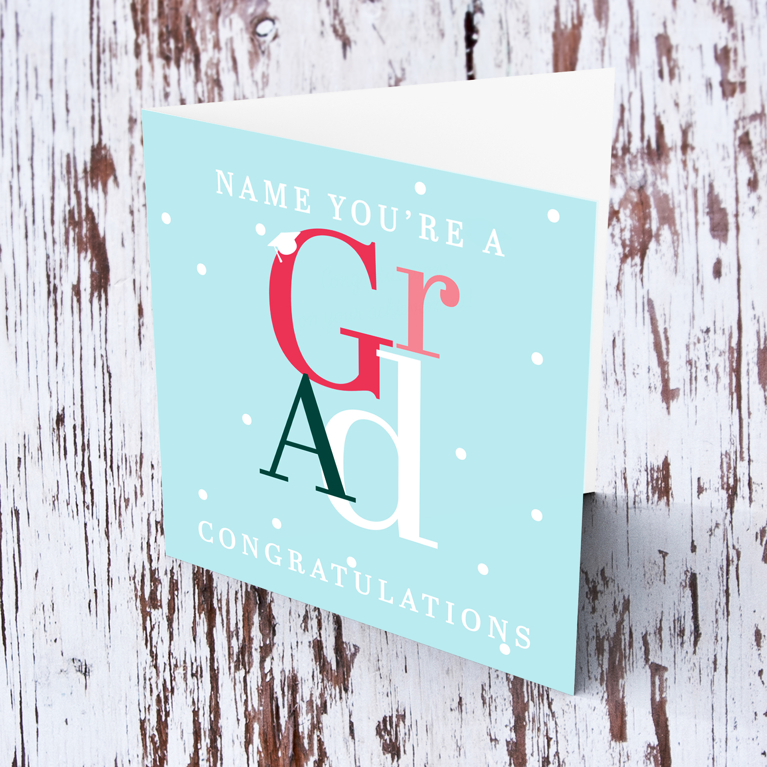 Modern graduation card in light blue background, featuring colourful GRAD and other white text in English (Personalisable)