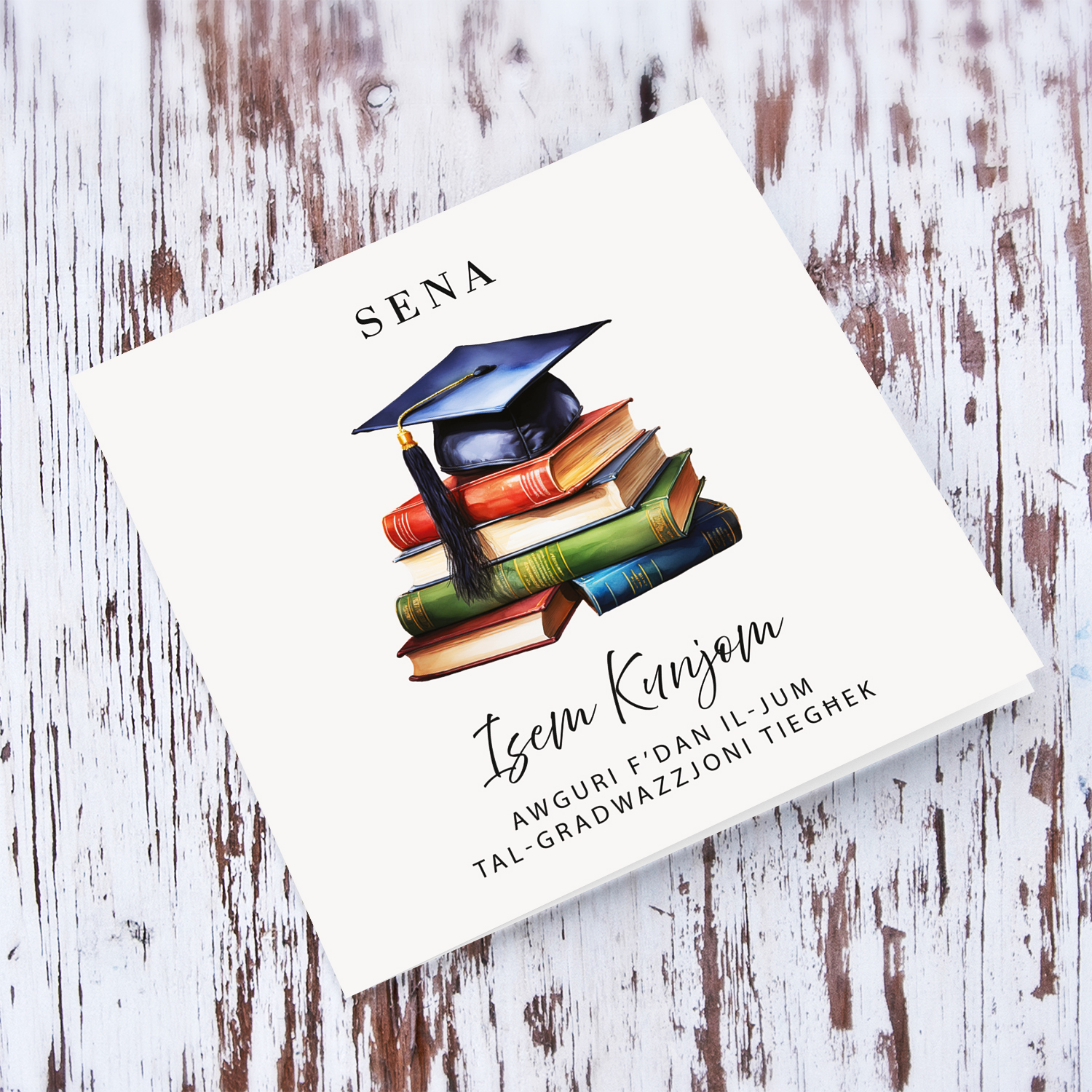 A graduation card featuring a graduation hat sitting on a stack of books in a neutral background in Maltese (Personalisable)