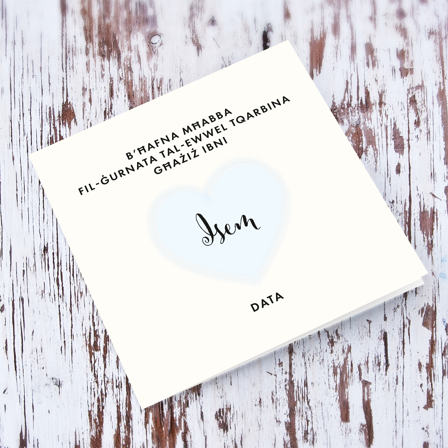 A minimalist Holy Communion card for Son featuring a light blue heart in Maltese (Personalisable)