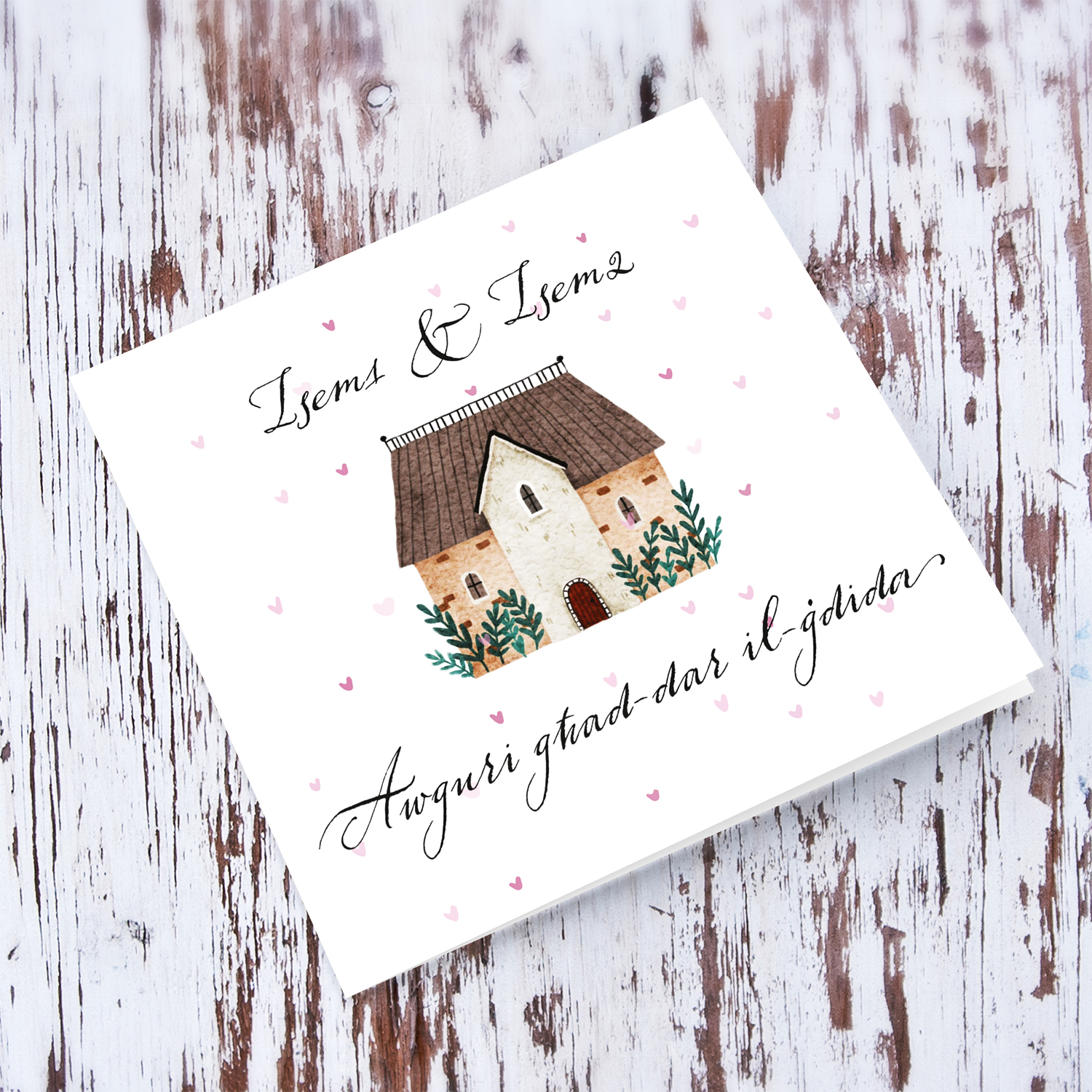 New home greeting card with scattered pink hearts and home illustration in Maltese (Personalisable 2 Names)