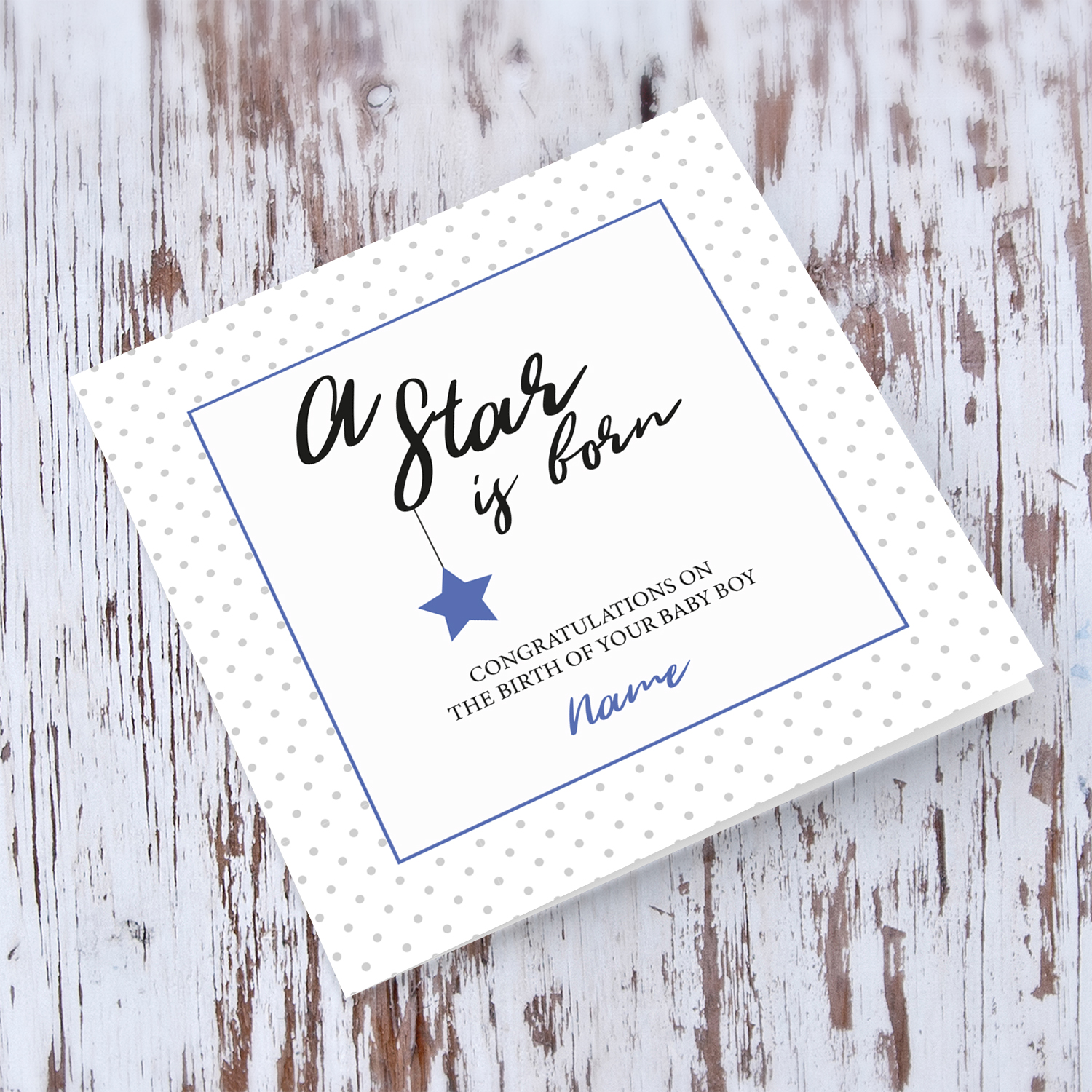 New born personalisable card for boys with polka dotted background and blue square with star in English