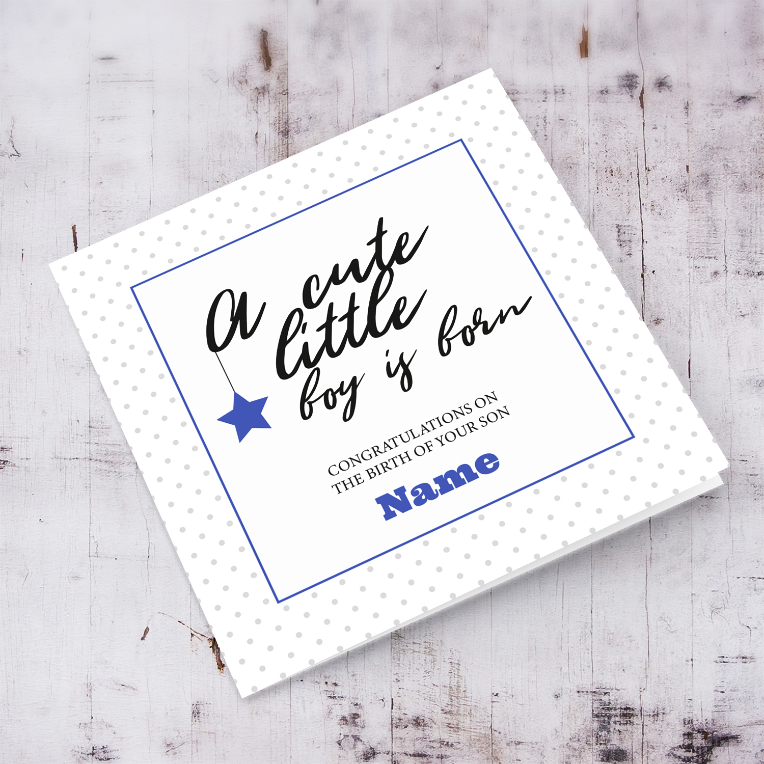 New born card for boys with polka dotted background and blue square with star in English - A cute little boy is born
