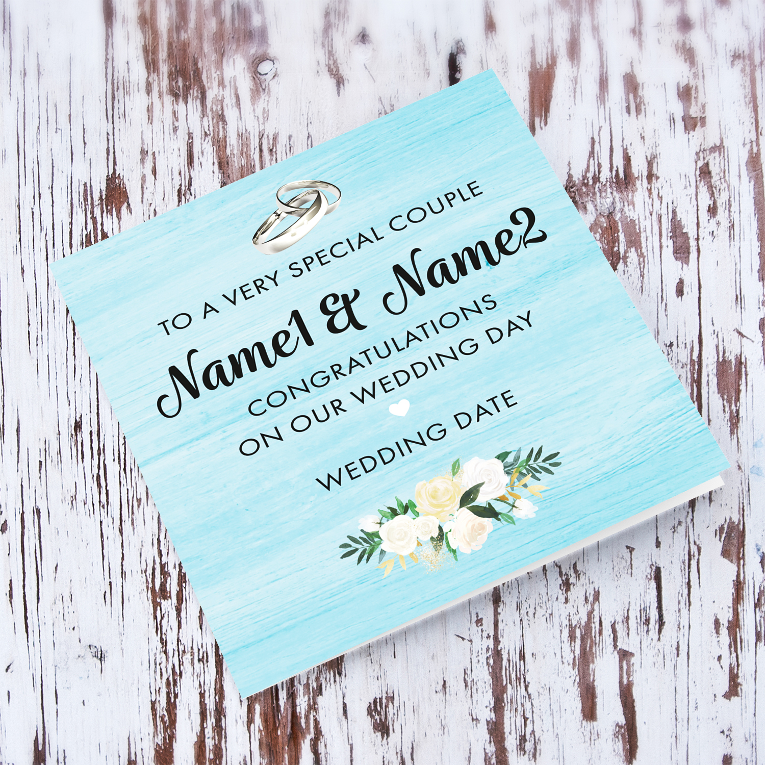 Light blue background wedding card with wedding bands and white flowers for a special couple in English