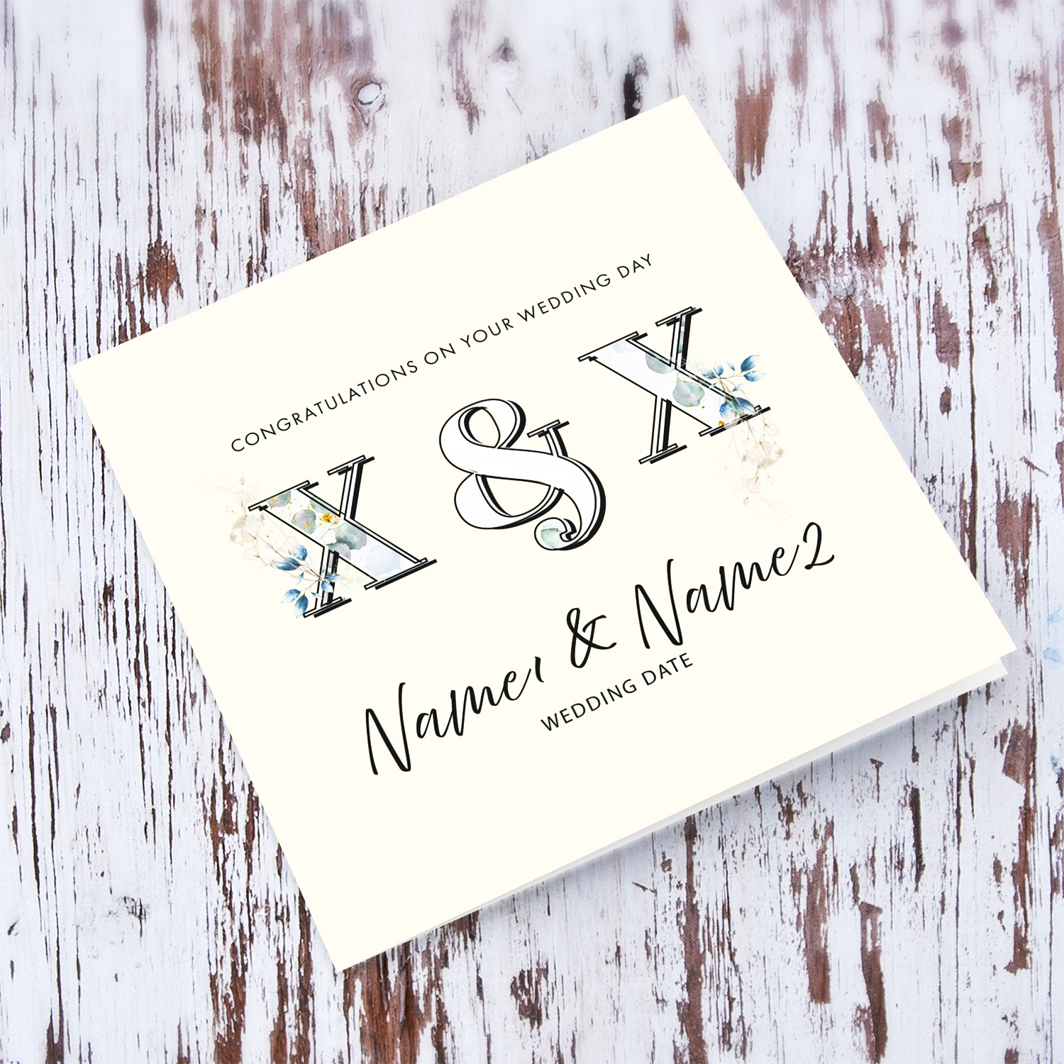 An elegant wedding card featuring couple's initials with floral / plant detail in cream background in English