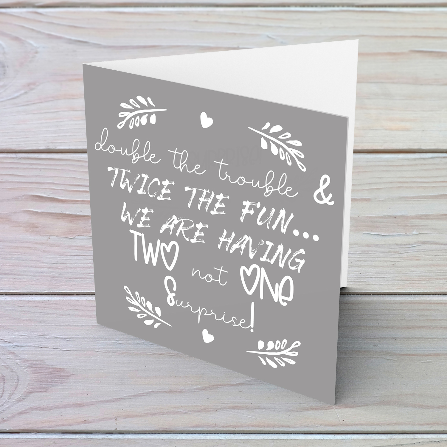 Twin baby announcement with grey background and white text in English