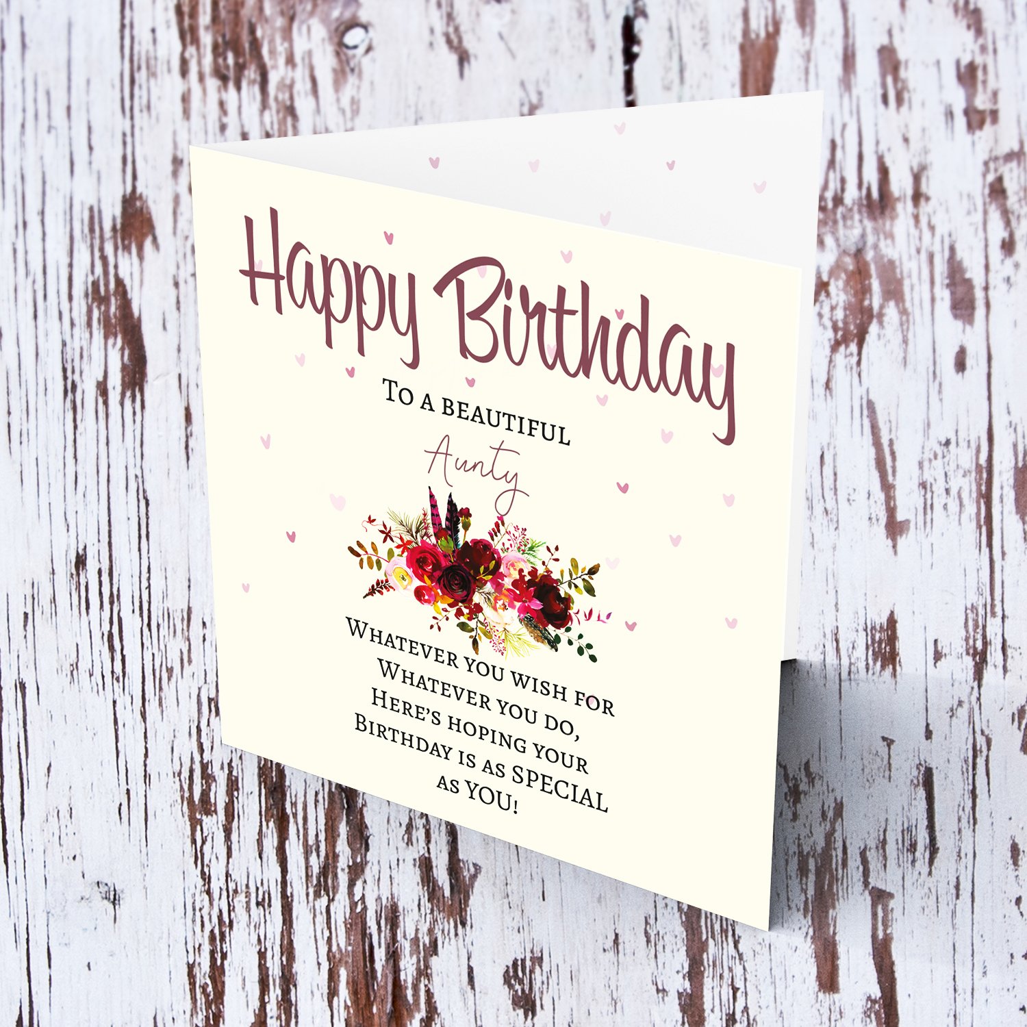 A birthday card with a special message with red tones colours and scattered hearts for Aunty in English