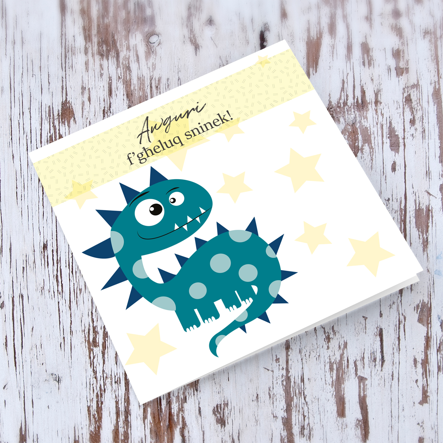 Dinosaur themed birthday card for boys with pastel yellow stars in Maltese