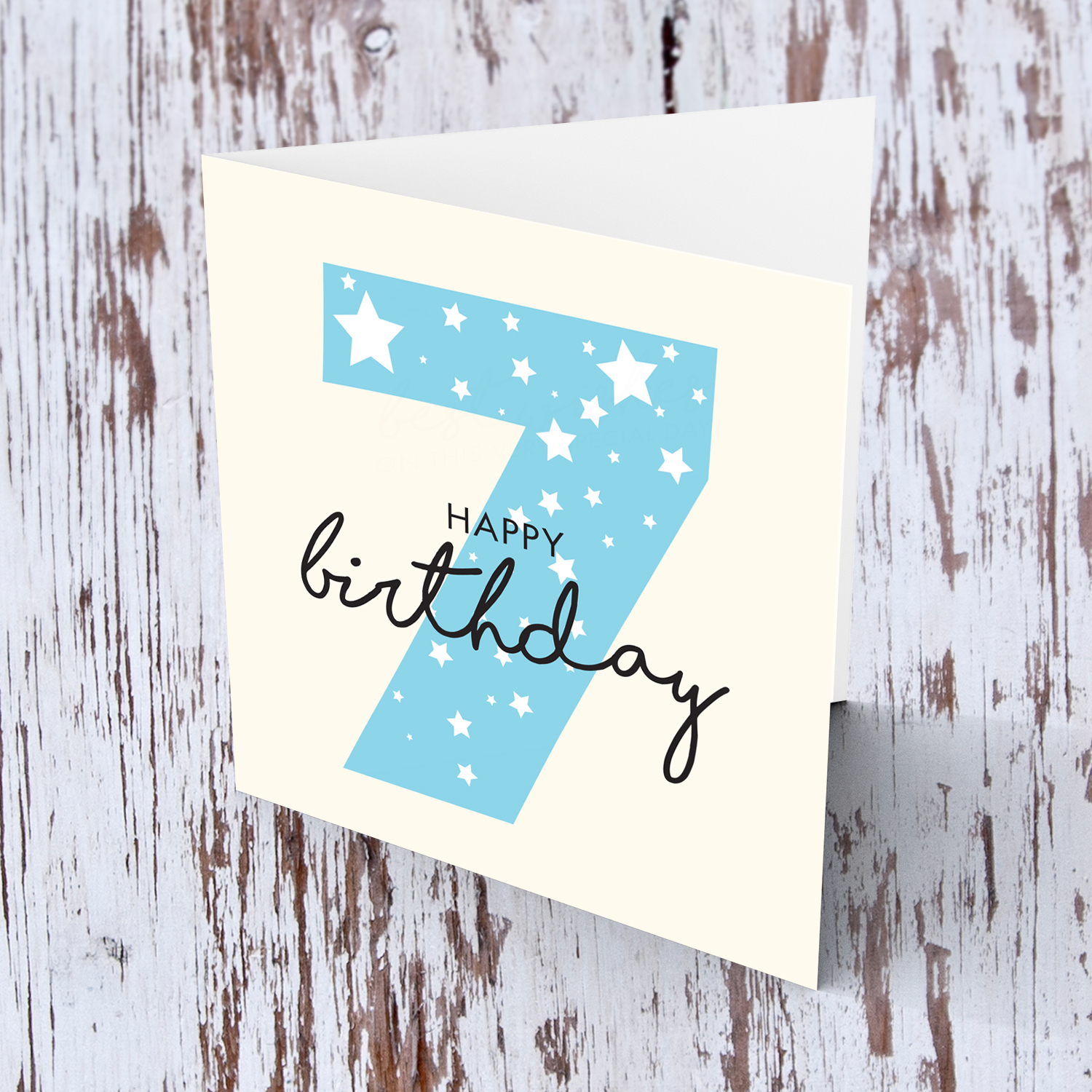 Blue number 7 with scattered white hearts birthday card in English