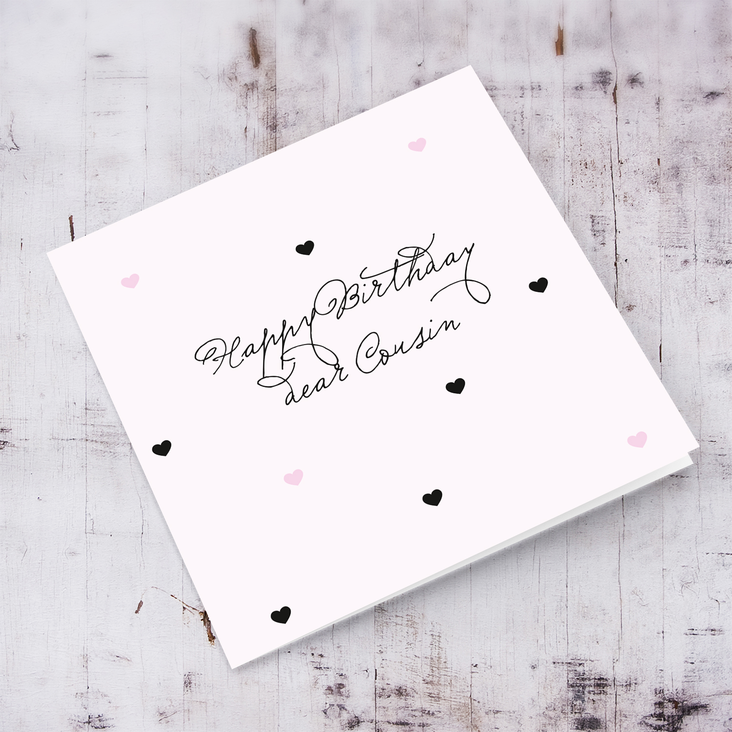 Light pink with scattered hearts birthday card for cousin in English