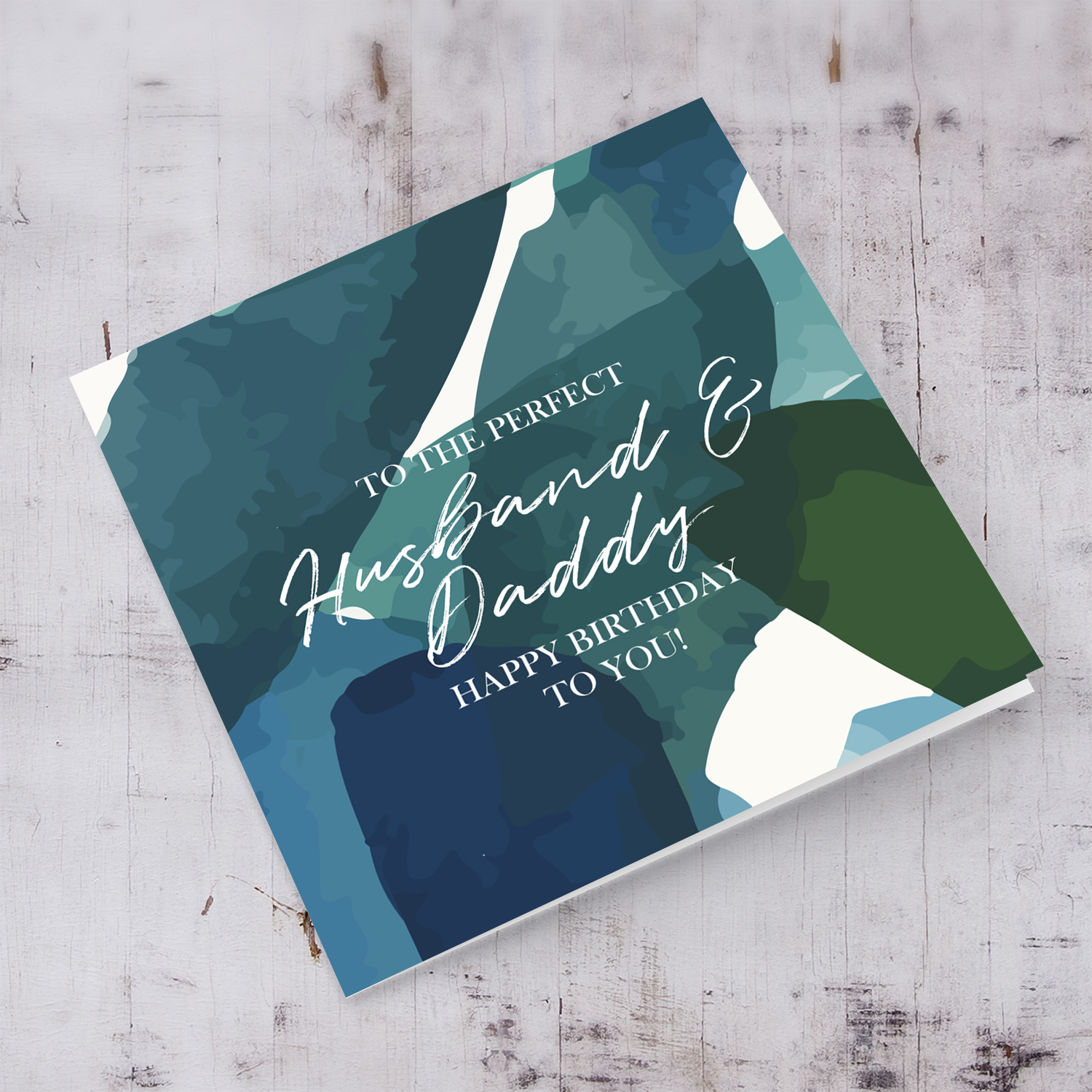 Best husband and Daddy birthday card with blue and green toned background in English