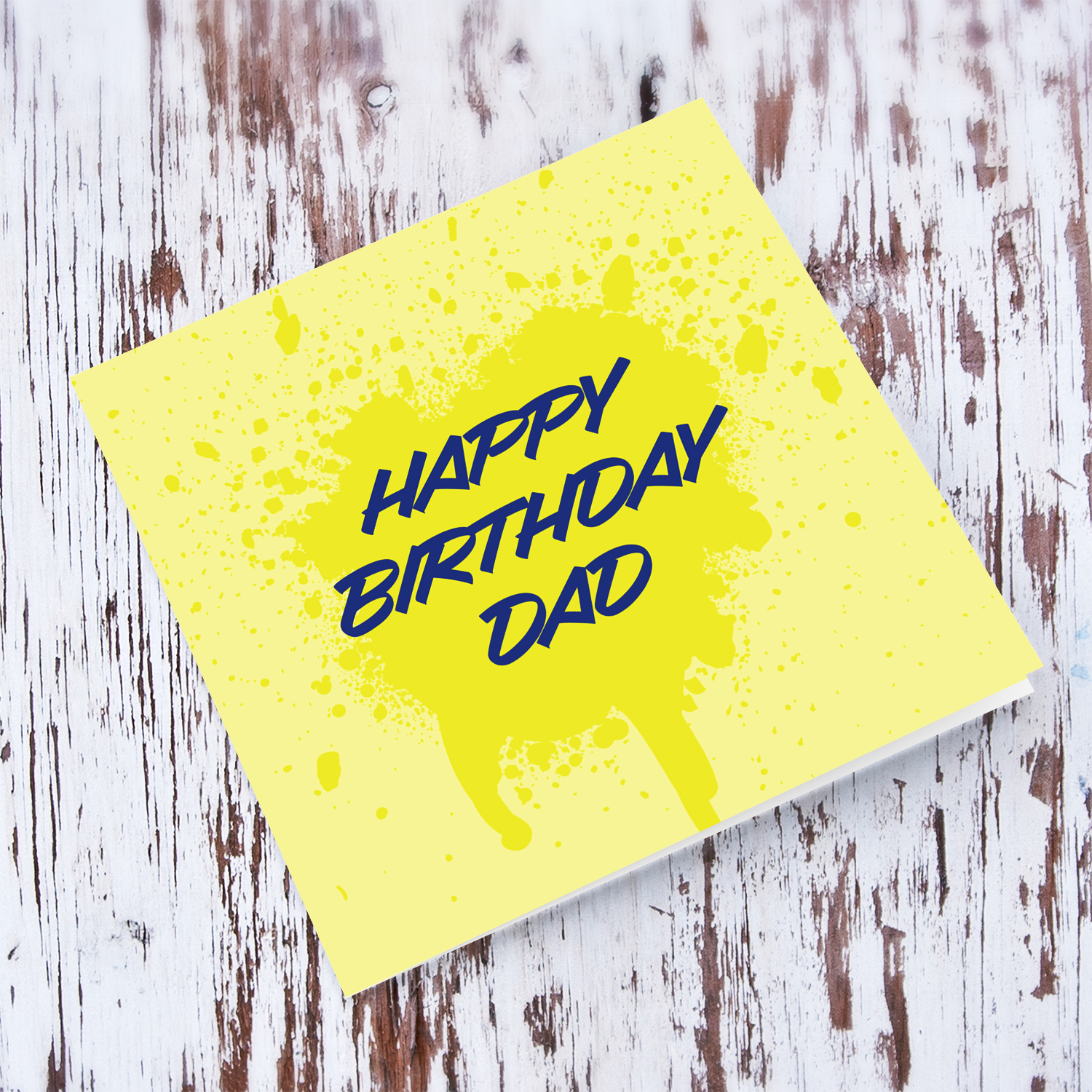Yellow splattered paint background with blue text birthday card for Dad in English