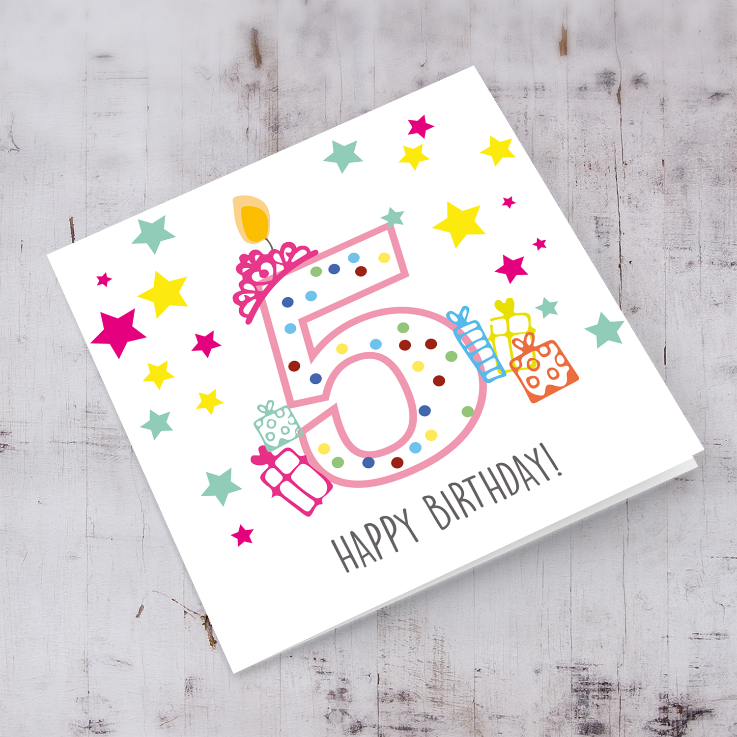 5th Birthday card for girls with crown and candle, with colourful stars and gifts in English