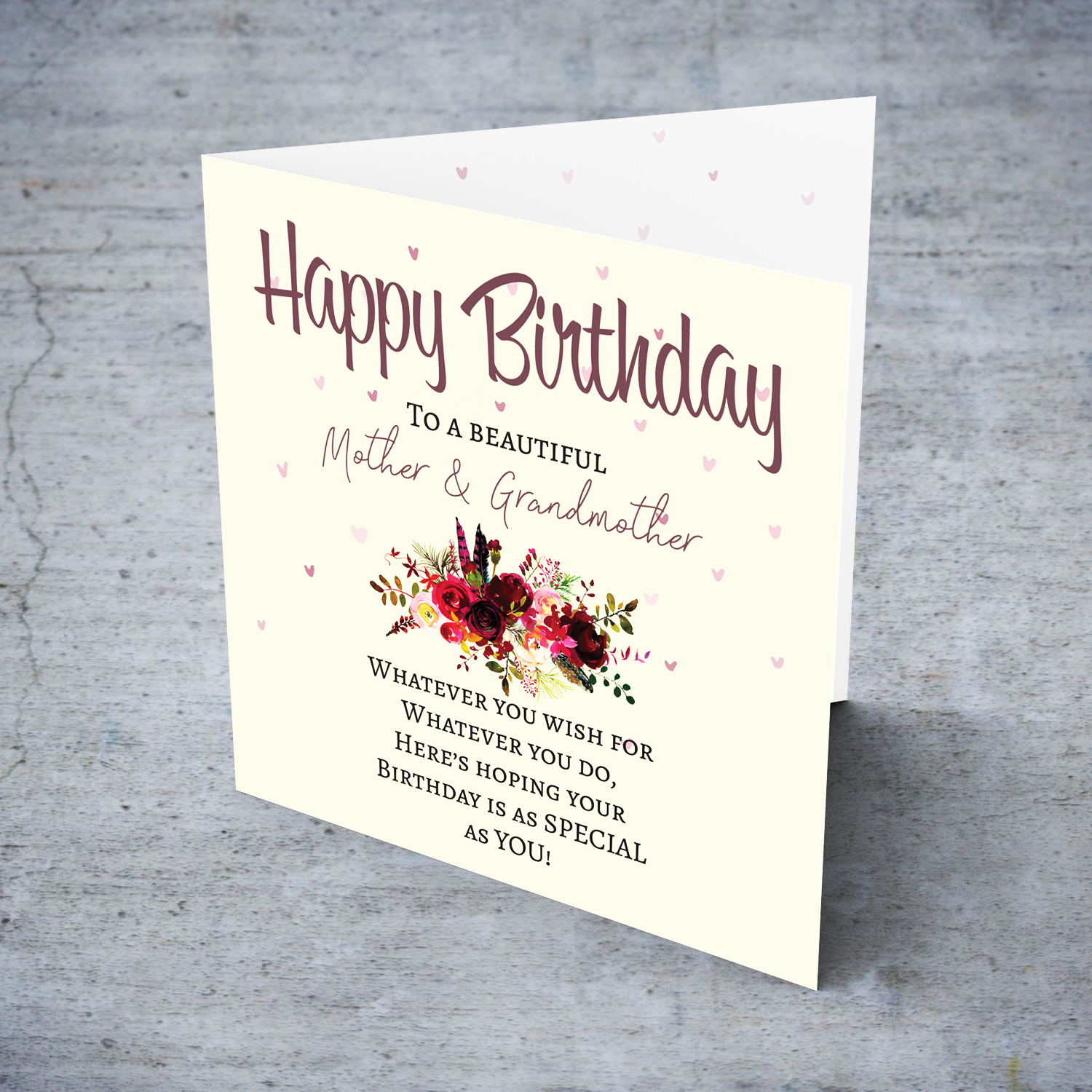 A birthday card with a special message with red tones colours and scattered hearts for mother & grandmother in English