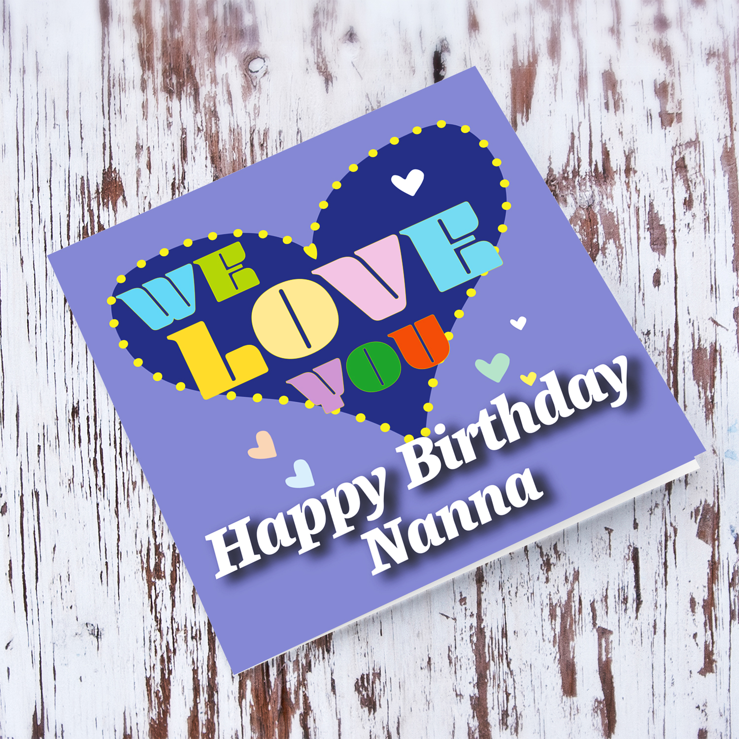 Purple background birthday card with big blue heart for Grandma, with a big WE LOVE YOU and scattered hearts in English