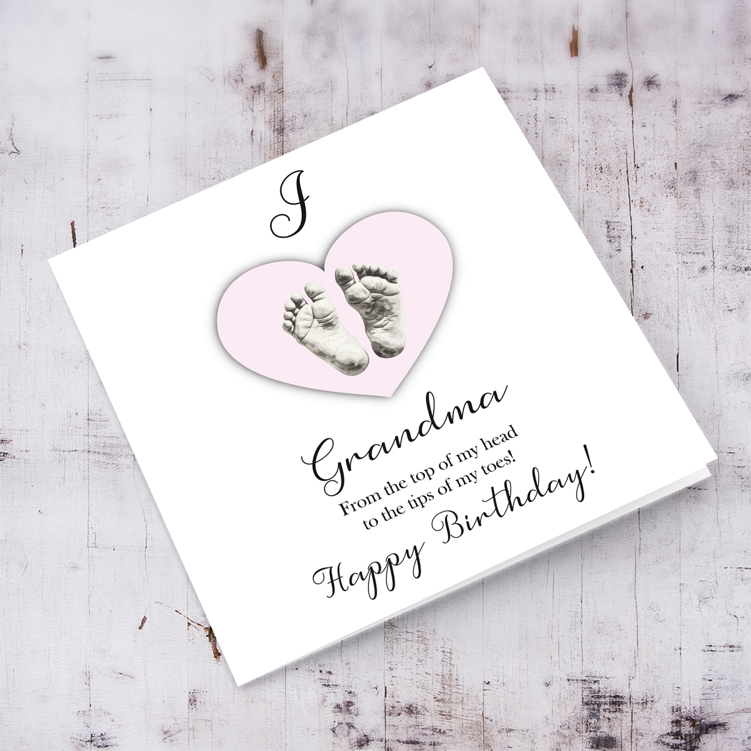 A cute baby footprint birthday card for grandma, I love Grandma, in a light pink heart in English