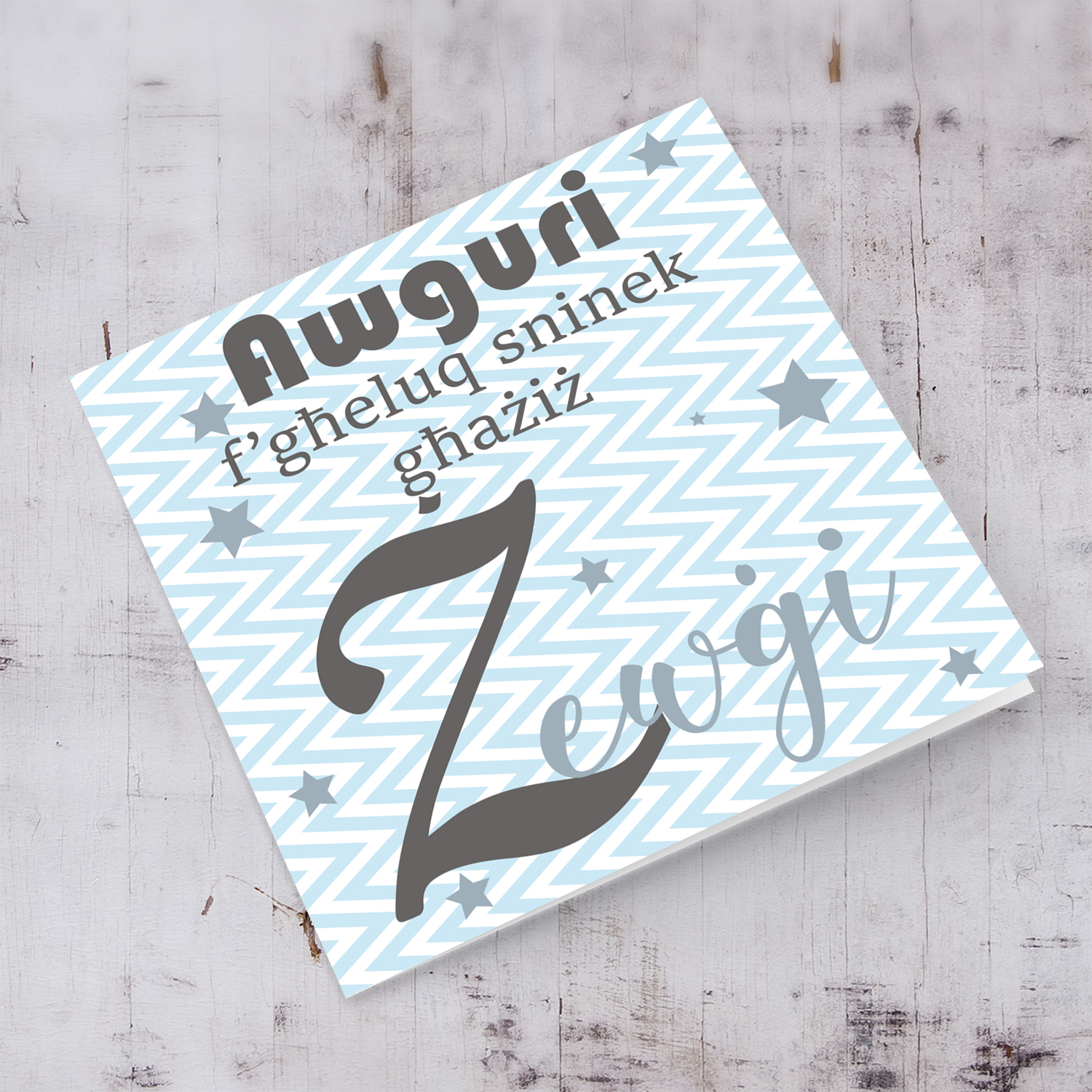 Blue with zigzag background and scattered stars birthday card for husband in Maltese
