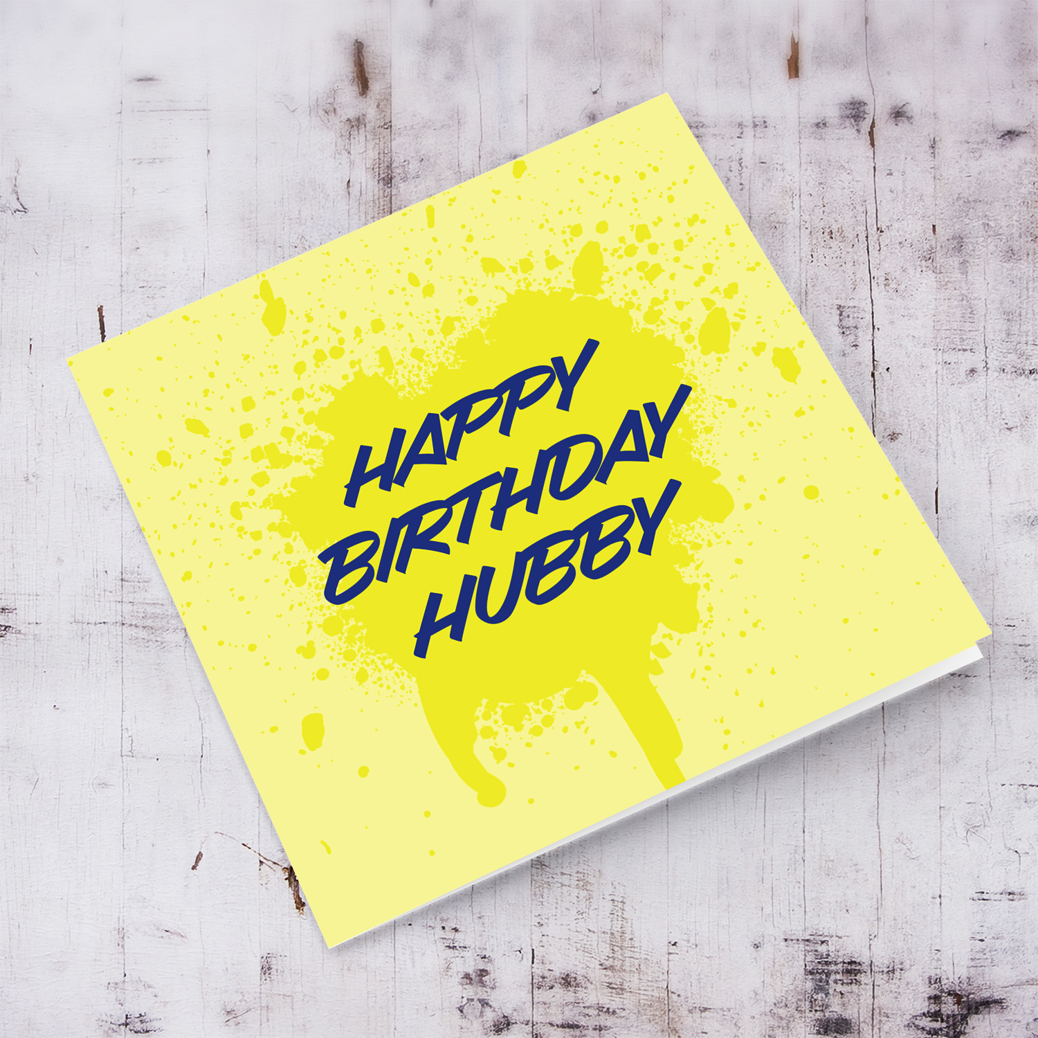 Yellow splattered paint background with blue text birthday card for husband in English