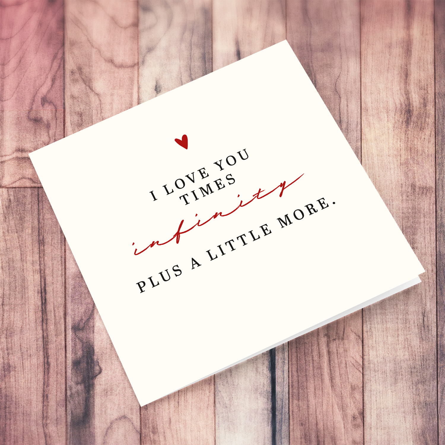 Minimalist open card in black and red text, with small red heart in English