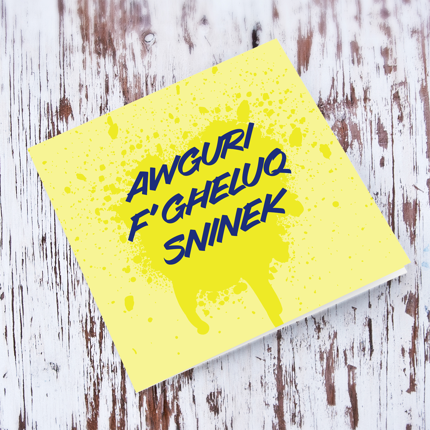 Yellow splattered paint background with blue text birthday card in Maltese
