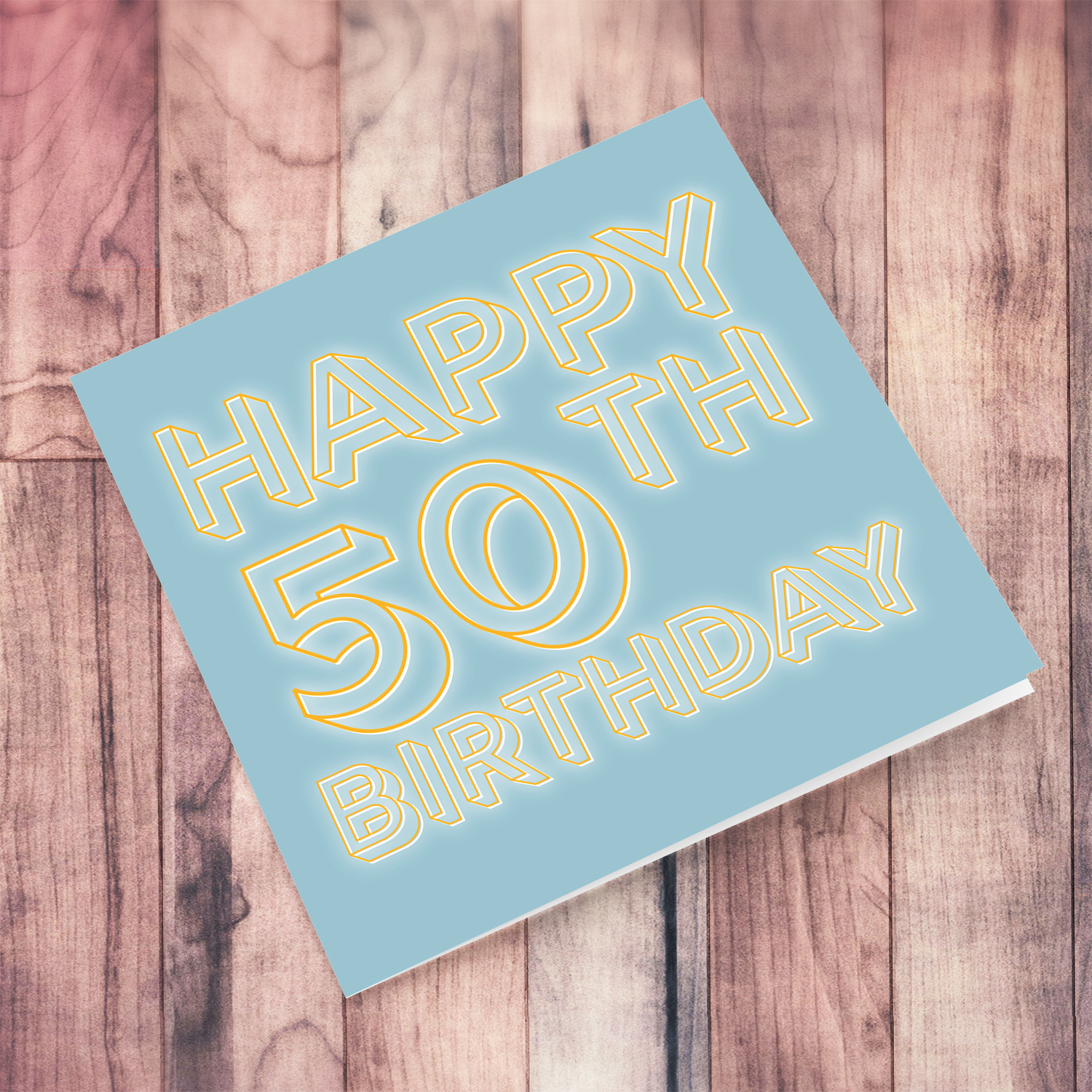 50th Birthday card with blue/grayish background and orange text with a white glow in English