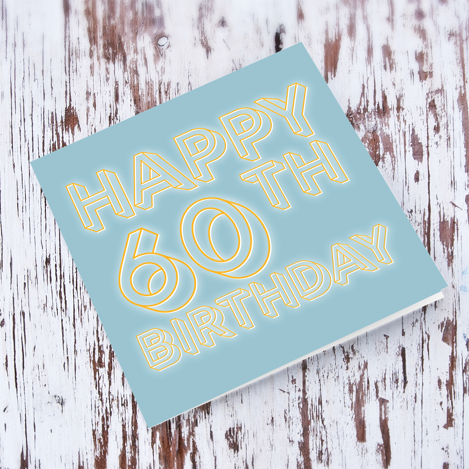 60th Birthday card with blue/grayish background and orange text with a white glow in English