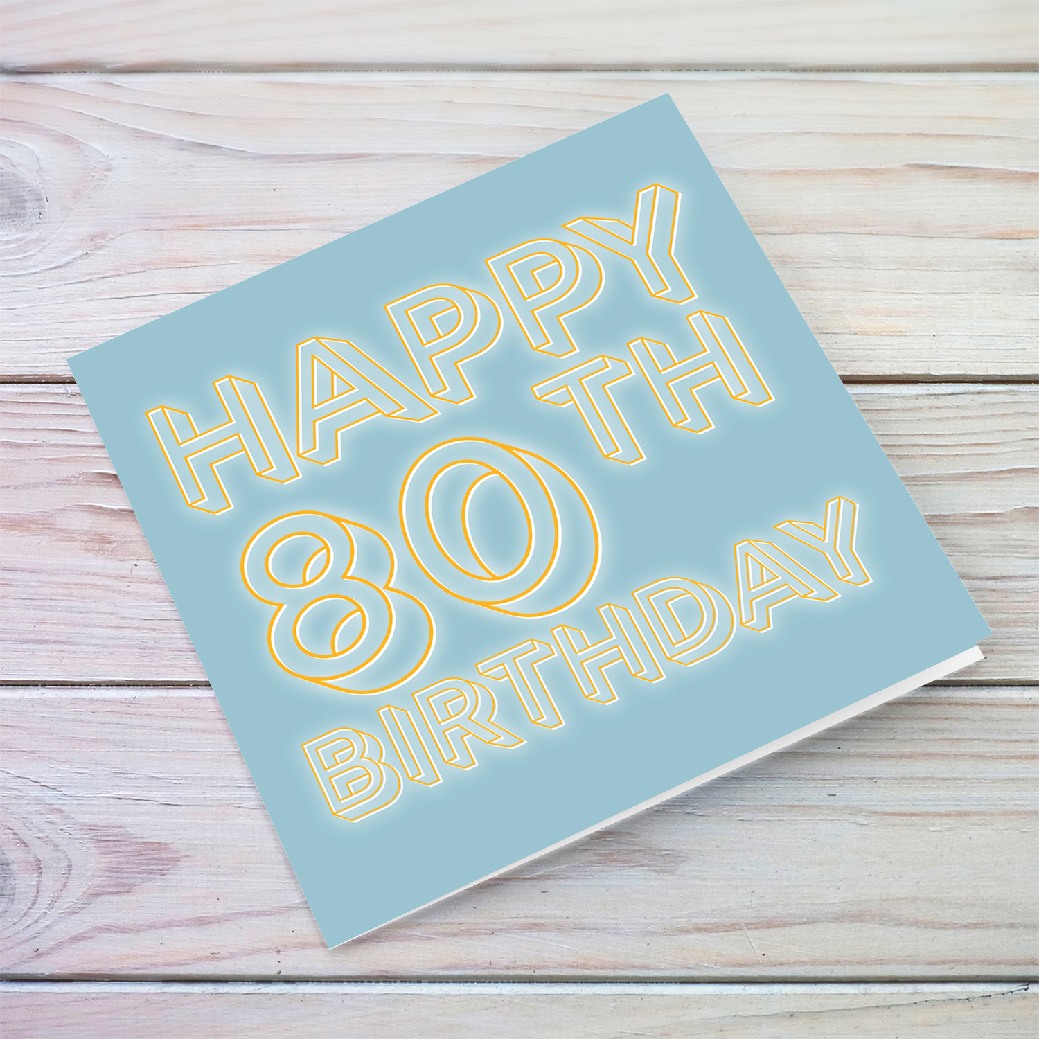 80th Birthday card with blue/grayish background and orange text with a white glow in English