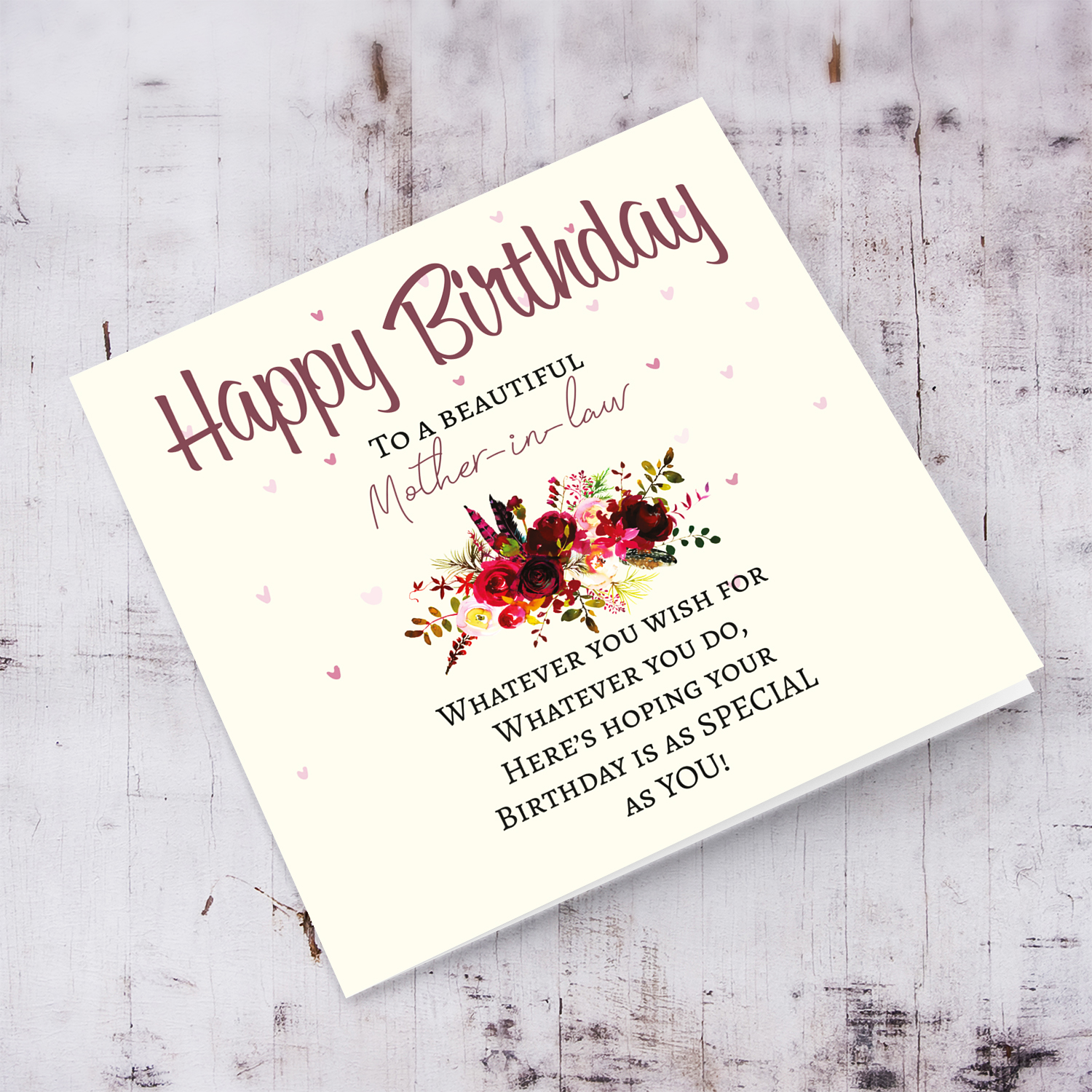 A birthday card with a special message with red tones colours and scattered hearts for mother in law in English
