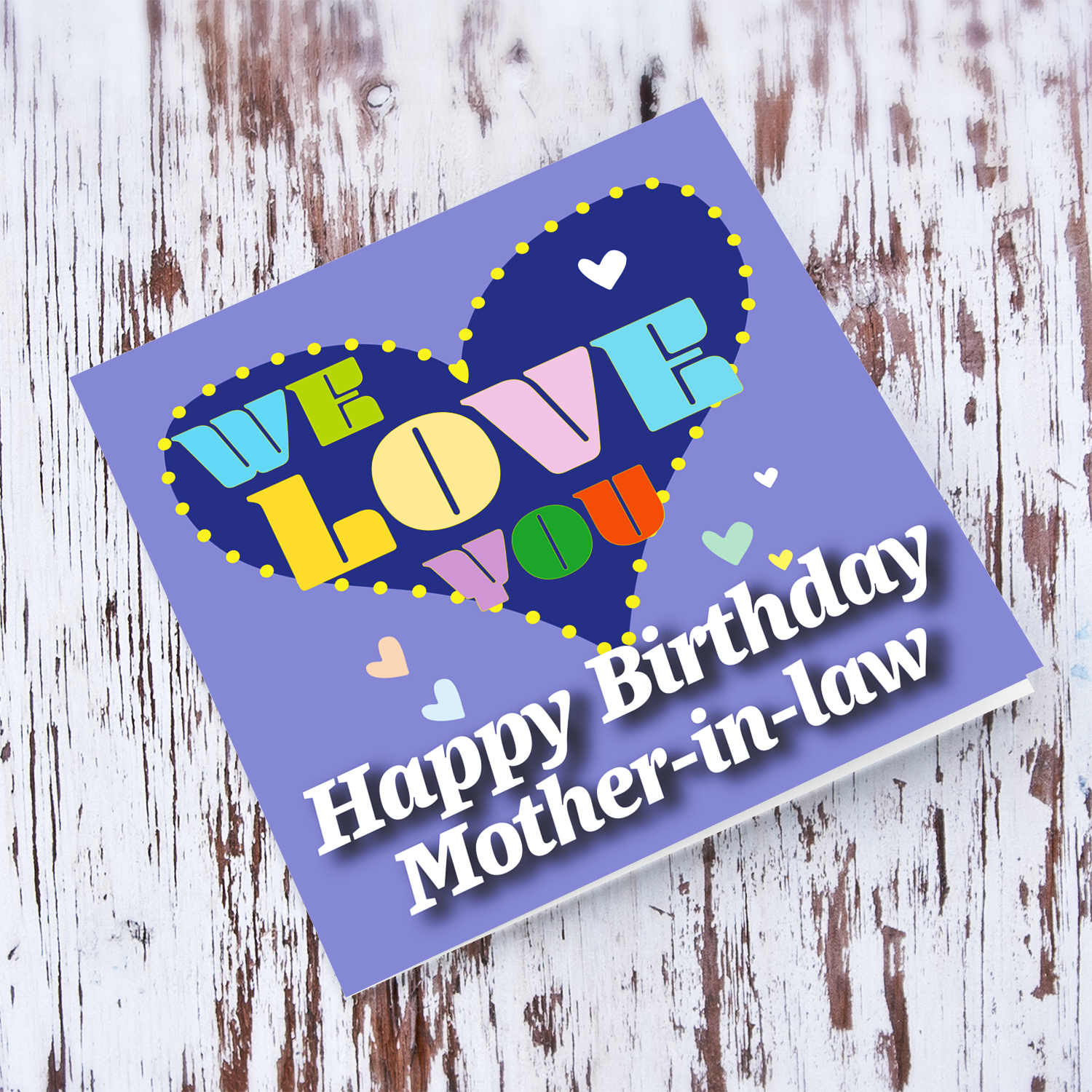 Purple background birthday card with big blue heart for mother-in-law, with a big WE LOVE YOU and scattered hearts in English