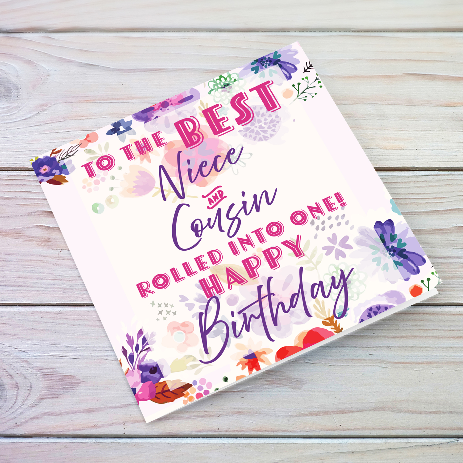 A beautiful birthday card featuring purple flowers, pink and purple text for Niece & Cousin in English