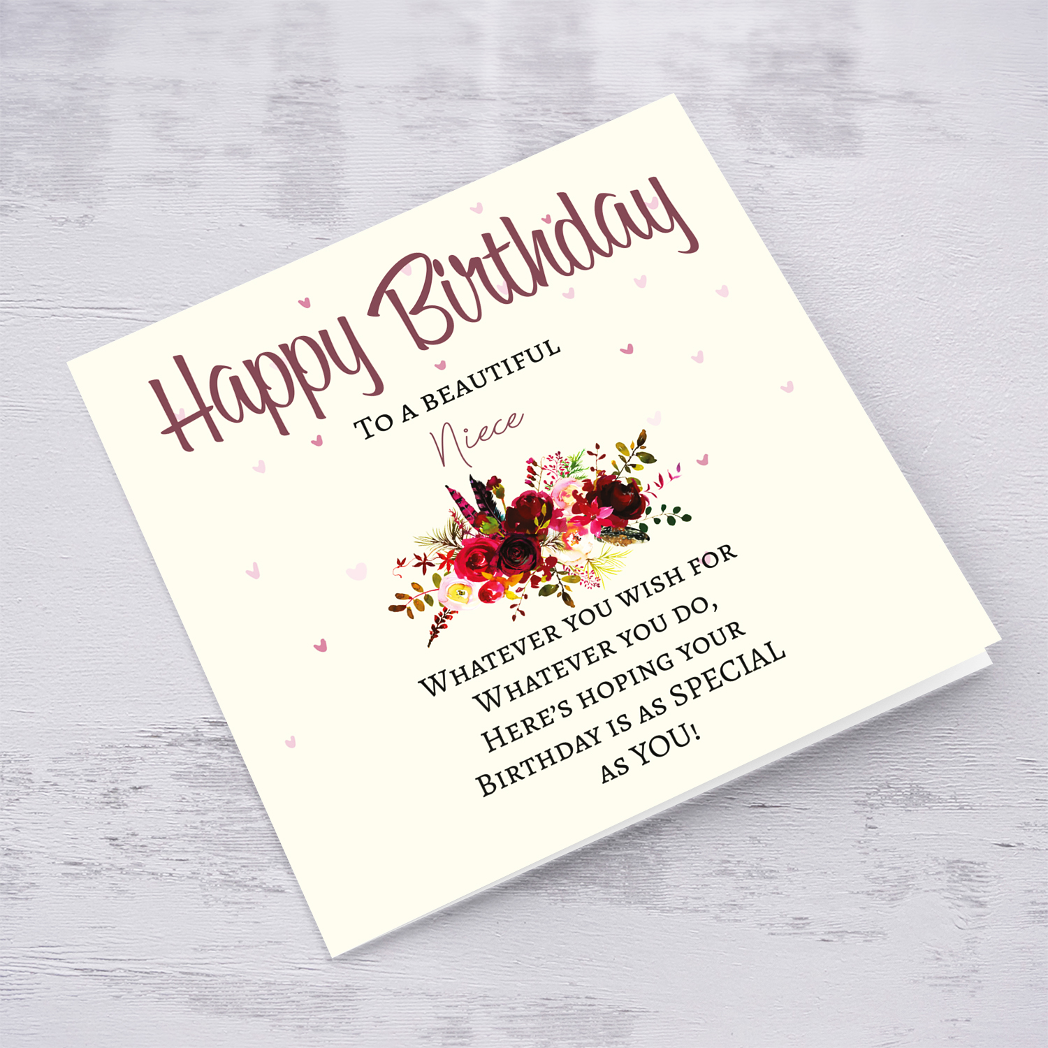 A birthday card with a special message with red tones colours and scattered hearts for Niece in English