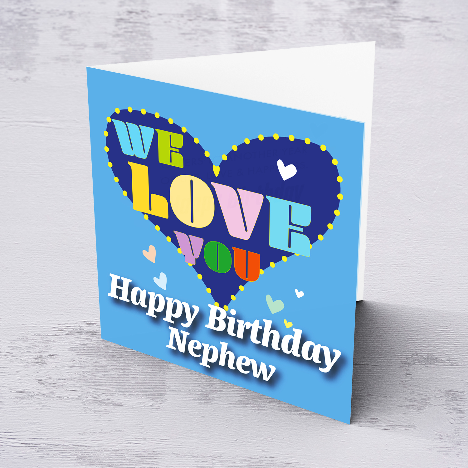 Blue background birthday card with big blue heart for nephew, with a big WE LOVE YOU and scattered hearts in English