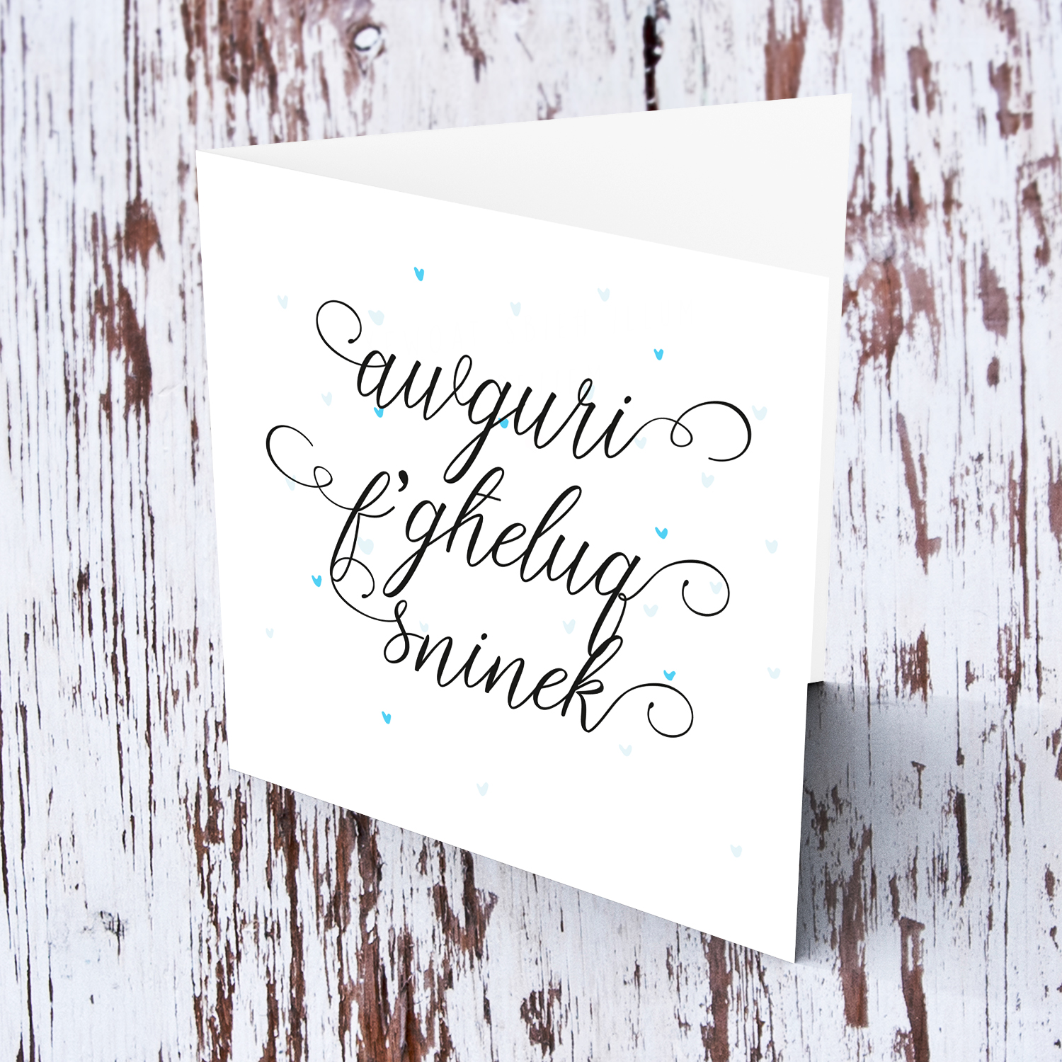 Minimalist open birthday card with scattered light blue hearts in Maltese