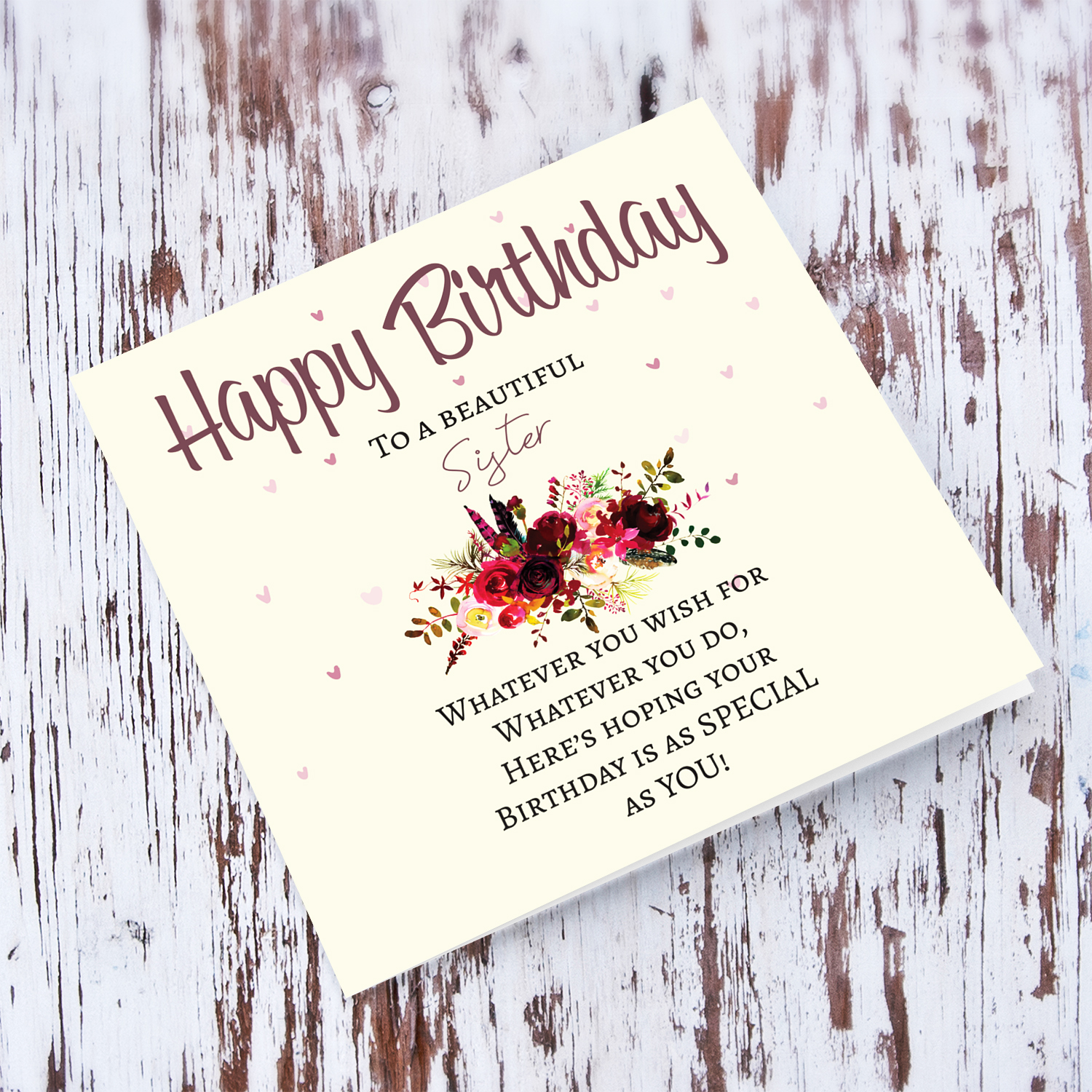 A birthday card with a special message with red tones colours and scattered hearts for a beautiful Sister in English