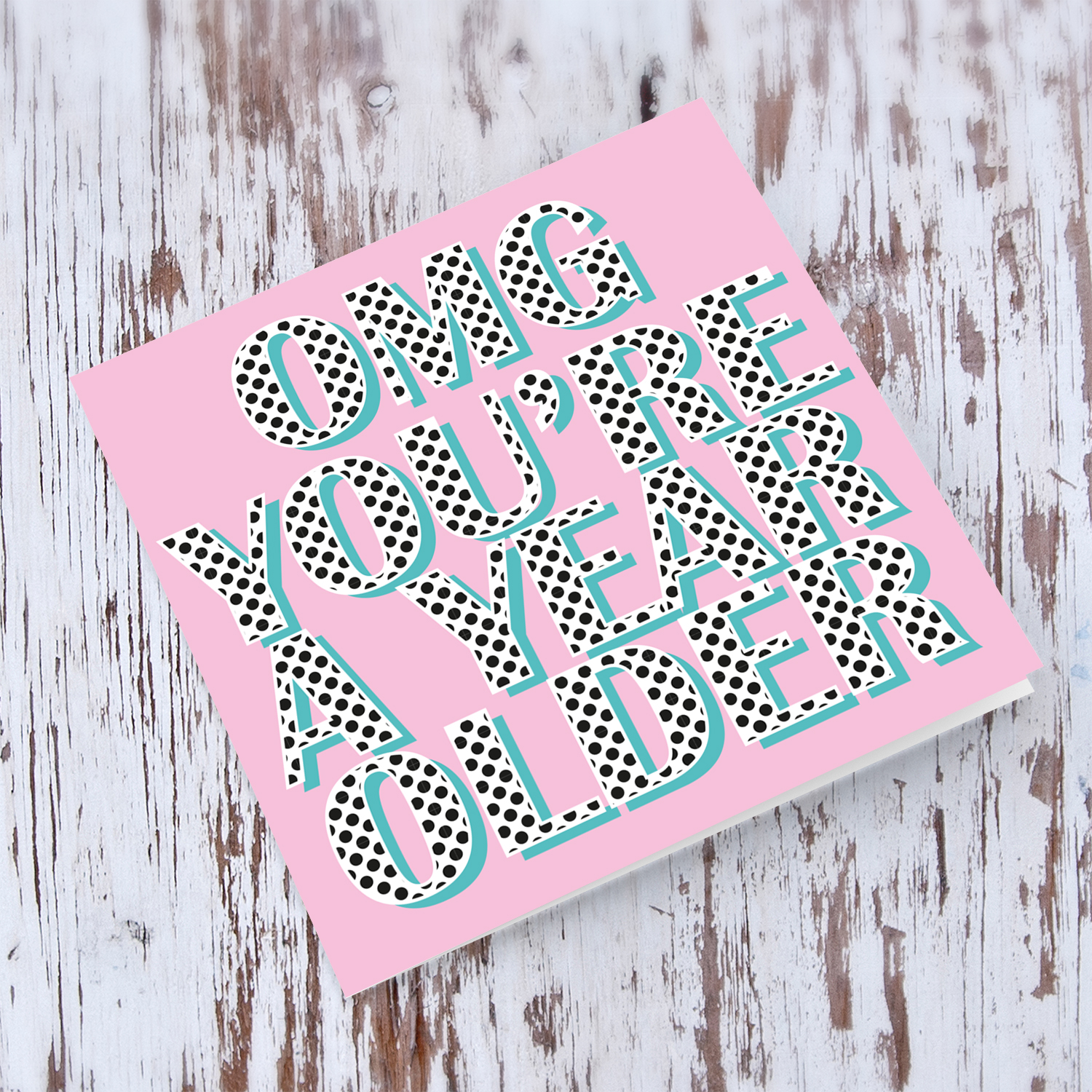 Pink background with polka dot wording you're a year older birthday card in English